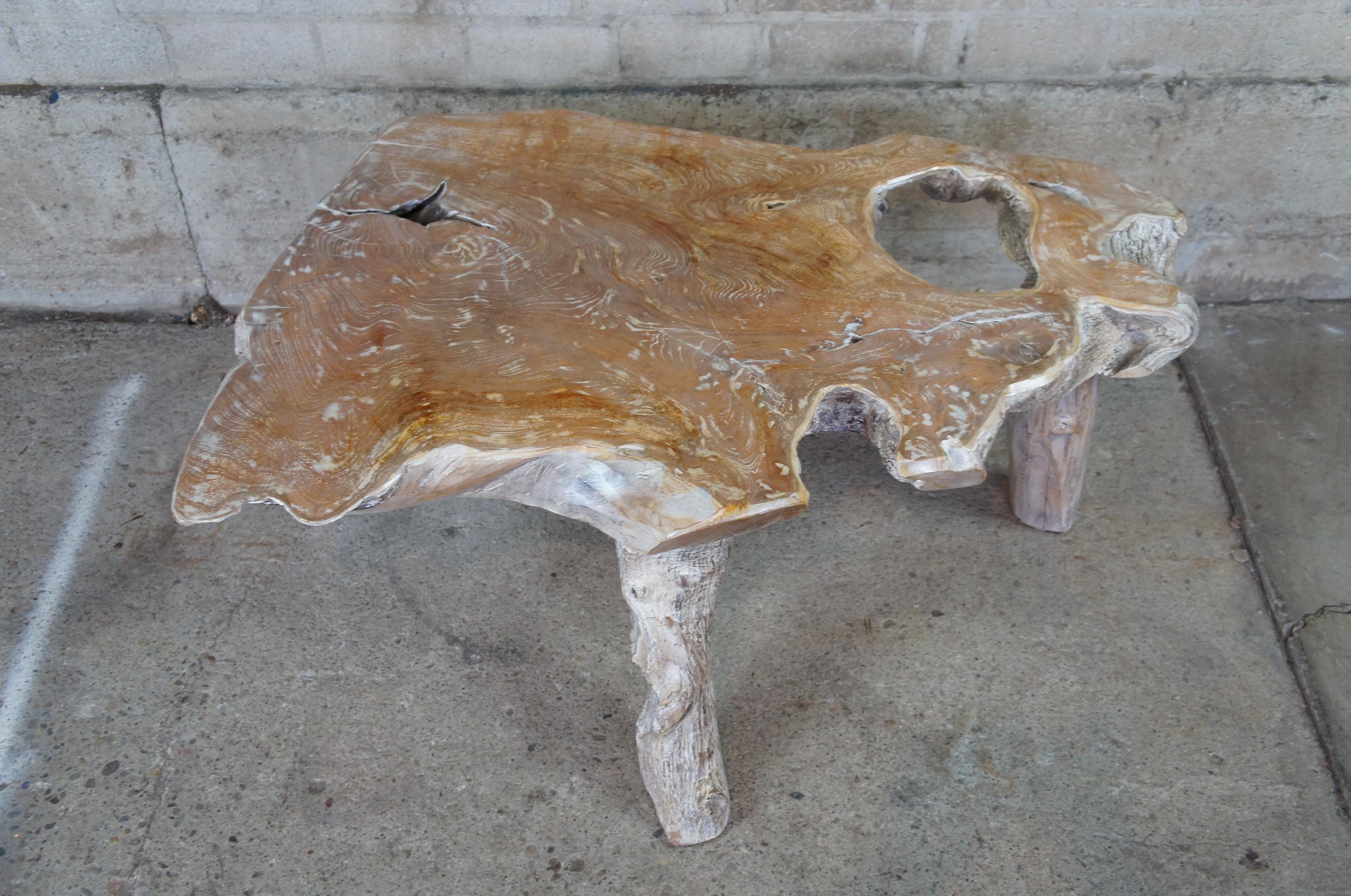 Vintage live edge slab coffee table. Made of teak wood featuring natural accents. Measure: 44
