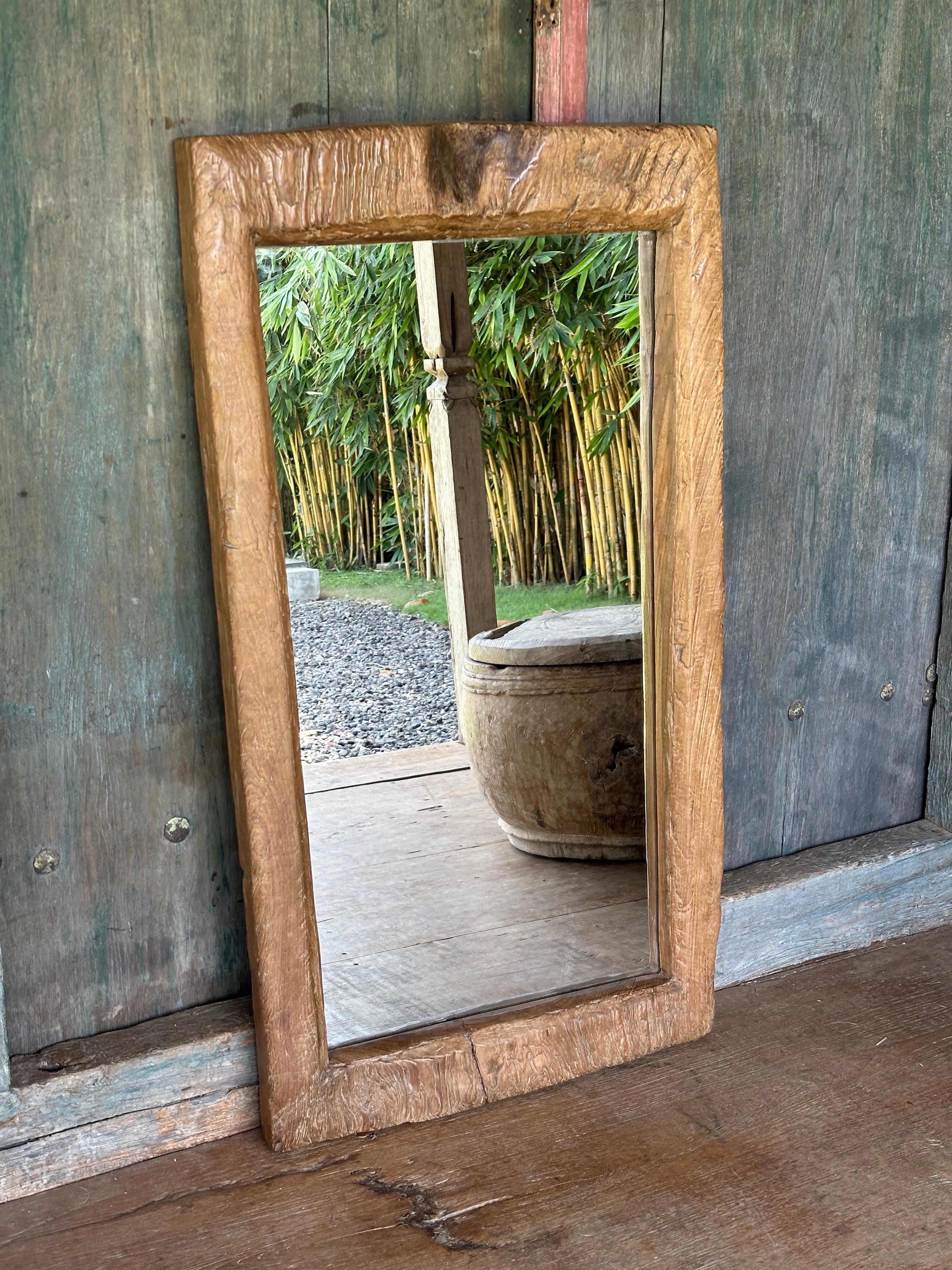 A wonderfully unique mirror crafted from wood sourced from an antique, solid teak wood Lesung. Lesungs are rice mortars found on the island of java used to remove rice husks. The wood used for this mirror was sourced from the top side of the Lesung,