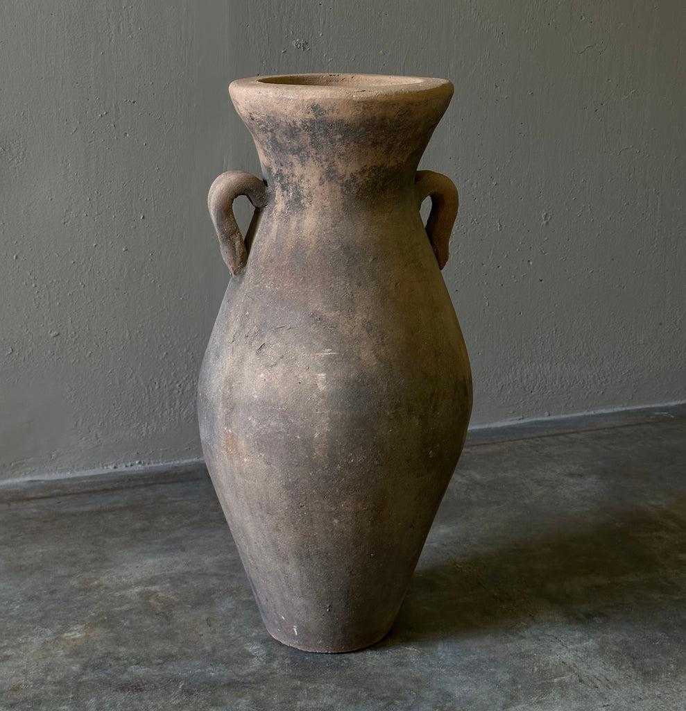 Decorative terracotta vessel from Jalisco, Mexico, with traditional amphora shape and wonderful handmade quality. A one of a kind piece that adds touch of rustic elegance to any space. 

