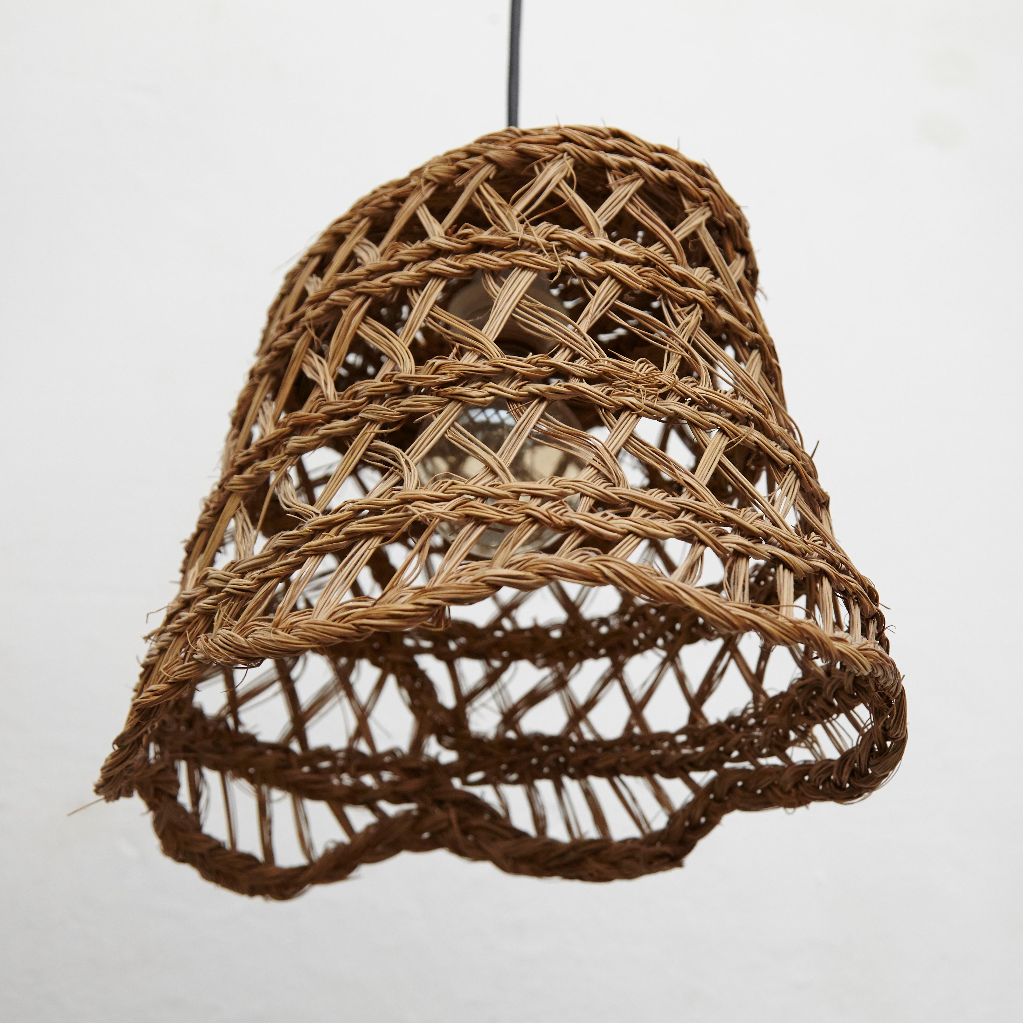 Rustic traditional rattan ceiling lamp by unknown artisan, Spain, circa 1980.
In original condition, with minor wear consistent with age and use, preserving a beautiful patina.

Materials:
Rattan

Dimensions:
D 30 cm x W 37 cm x H 24