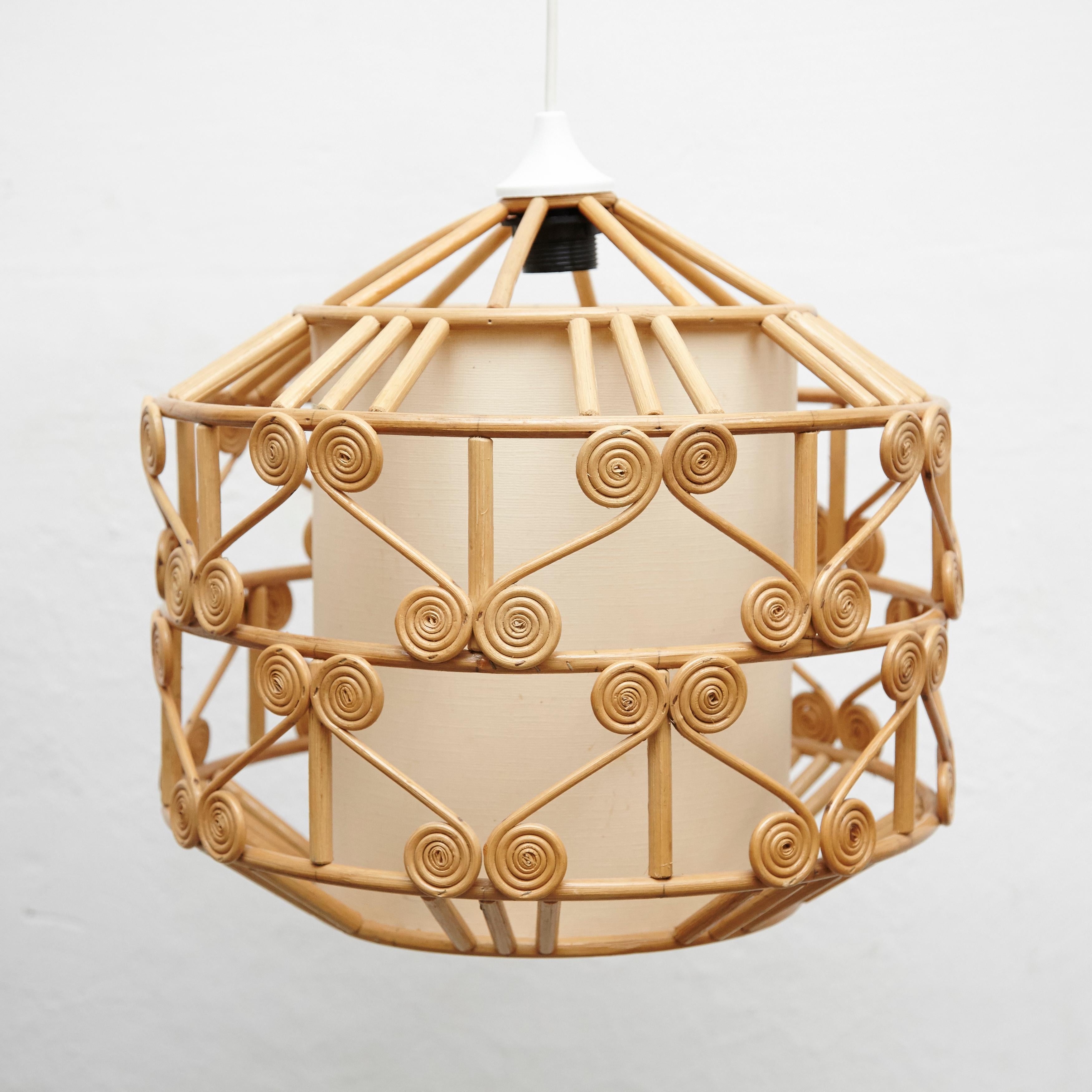Rustic traditional rattan ceiling lamp by unknown artisan, Spain, circa 1980.
In original condition, with minor wear consistent with age and use, preserving a beautiful patina.

Materials:
Rattan

Dimensions:
Ø 41 cm x H 41 cm.