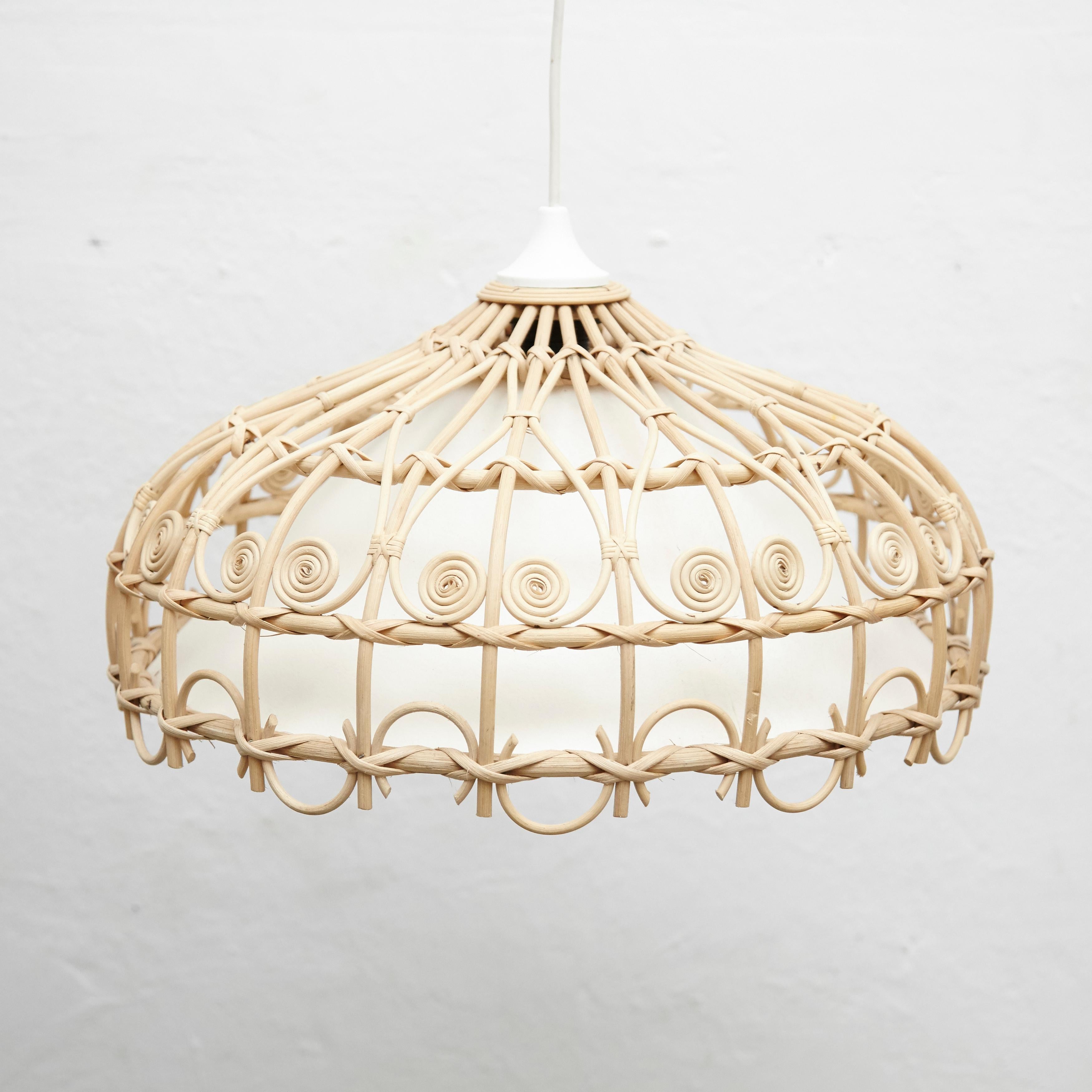 Rustic traditional Rattan ceiling lamp by unknown artisan, Spain, circa 1980.
In original condition, with minor wear consistent with age and use, preserving a beautiful patina.

Materials:
Rattan

Dimensions:
ø 47 cm x H 28 cm.