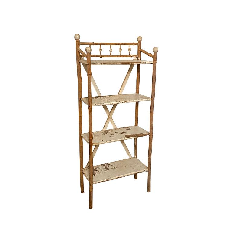 A tall rustic stick and ball bamboo bookcase. This piece features four shelves. The legs are created from bamboo and the back has an X stretcher which provides additional stability. The back is decorated at the top with stick and ball as well as on