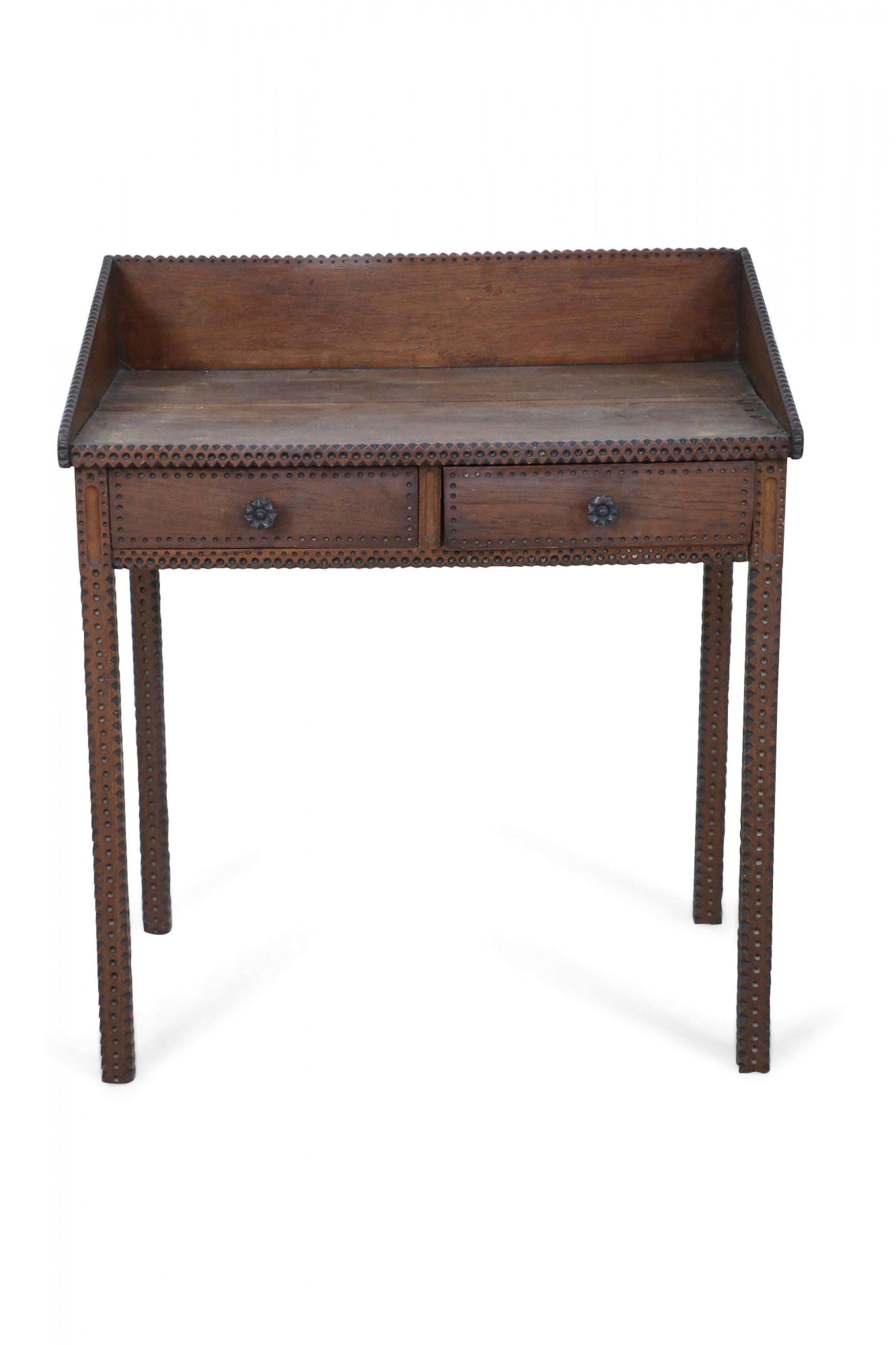 Rustic Tramp Art secretary desk with two drawers, a low back and side gallery, and notch-carved edges and legs.