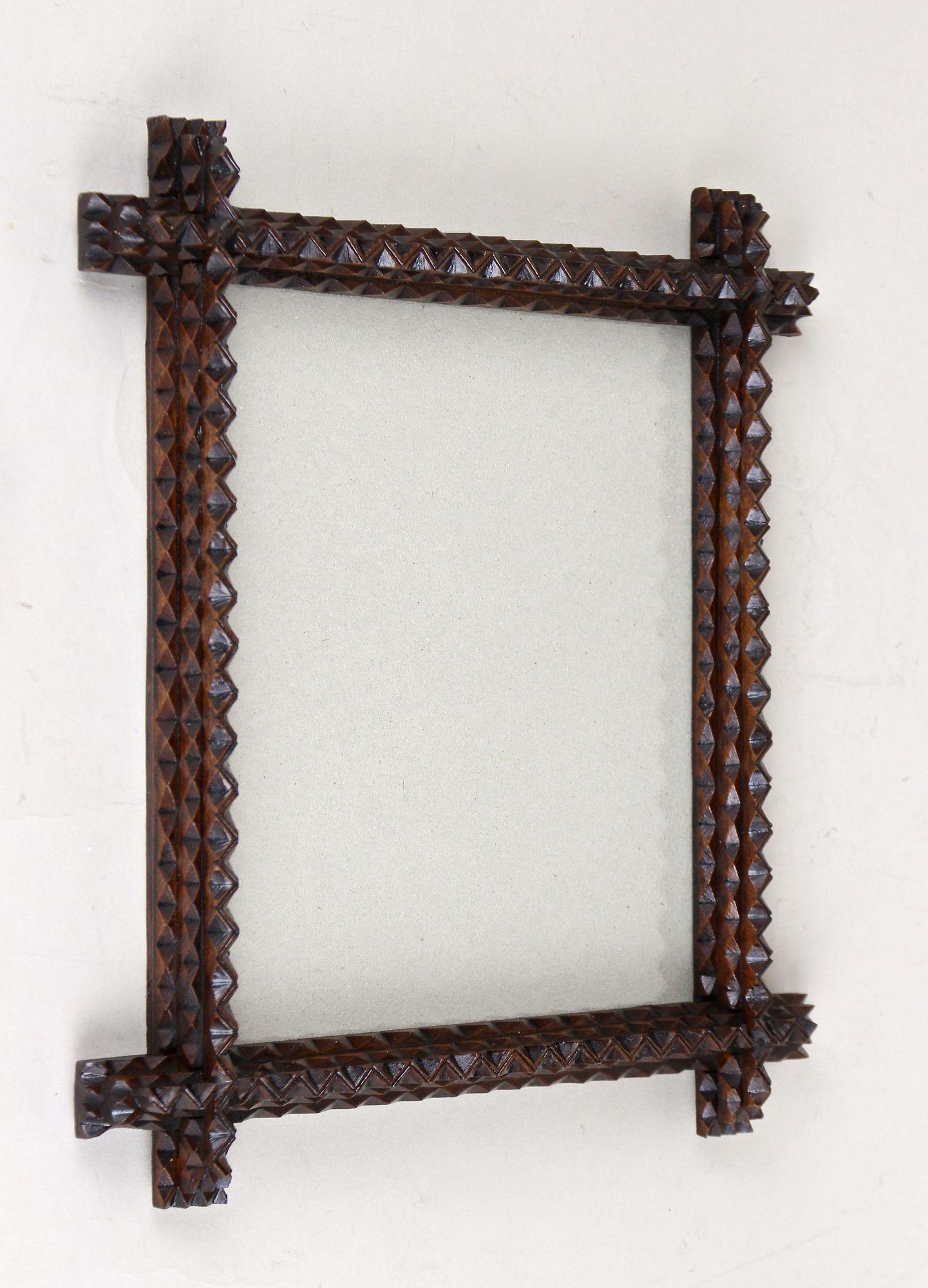 Lovely Tramp Art photo frame from the period in Austria around 1880. Elaborately hand carved out of bass this antique photo frame shows the beautiful so-called 