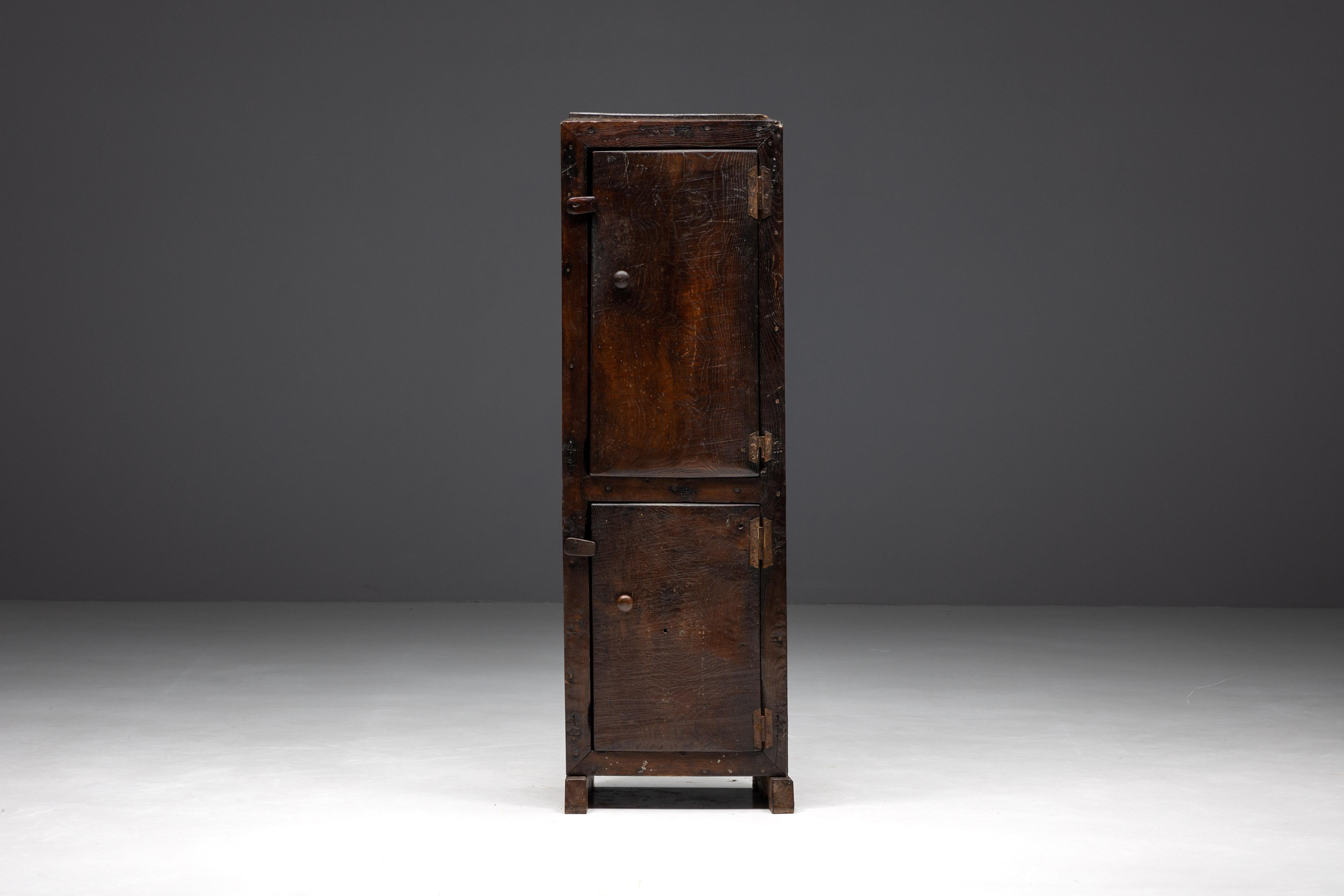 Rustic monoxylite cabinet from 19th century France, showcasing the timeless craftsmanship of that era. Its solid dark wood construction and one-of-a-kind monoxylite wooden back not only offer generous storage space and display options but also