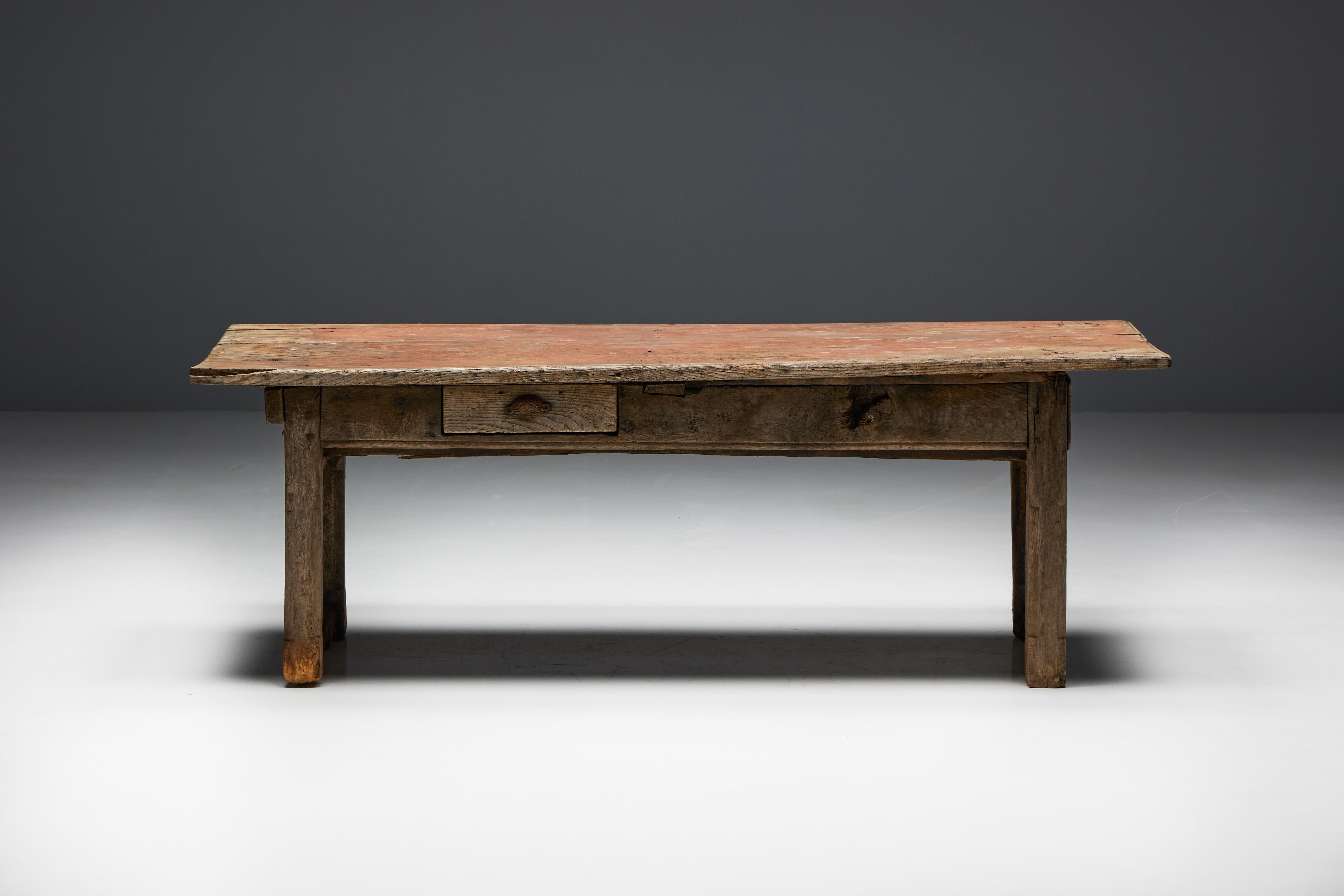 Crafted in 19th-century France, this farmhouse table beautifully embodies the essence of wabi design, featuring a charming natural patina that enhances its rustic allure. The convenience of a drawer on each side adds to its functionality, providing