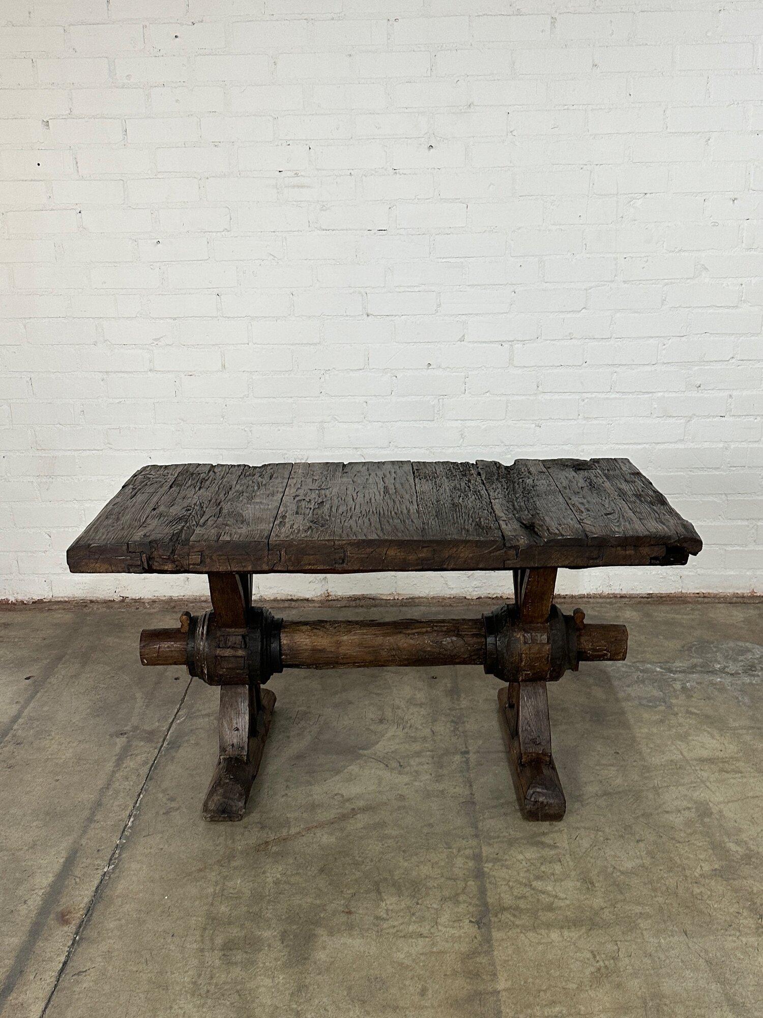 W58.5 D30 H31.5 KC28.25

Rustic Dining Table with a trestle base.  Table has a dark walnut stain and is made from solid wood, item shows natural wear consistent with the style. Base interlocks with the table top for easy disassembly. Table is