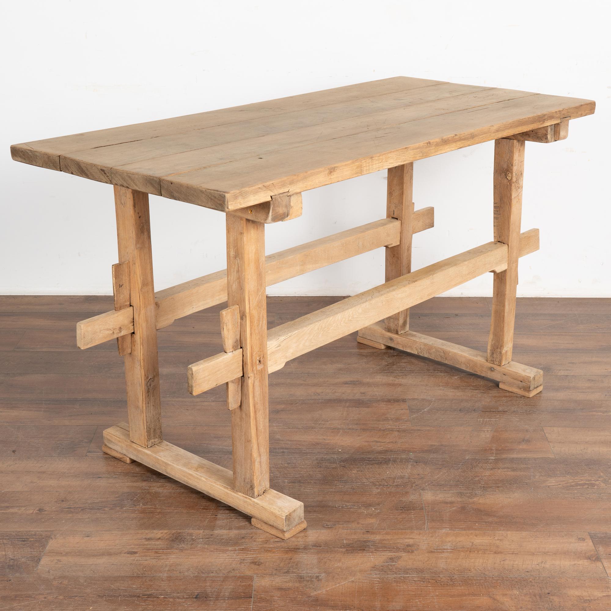 This wonderful old farm table from the European countryside will serve well as a rustic table in today's modern home.
This trestle table originally served as a  work table. Look at photos of the top to appreciate the gouges, scrapes, nicks and