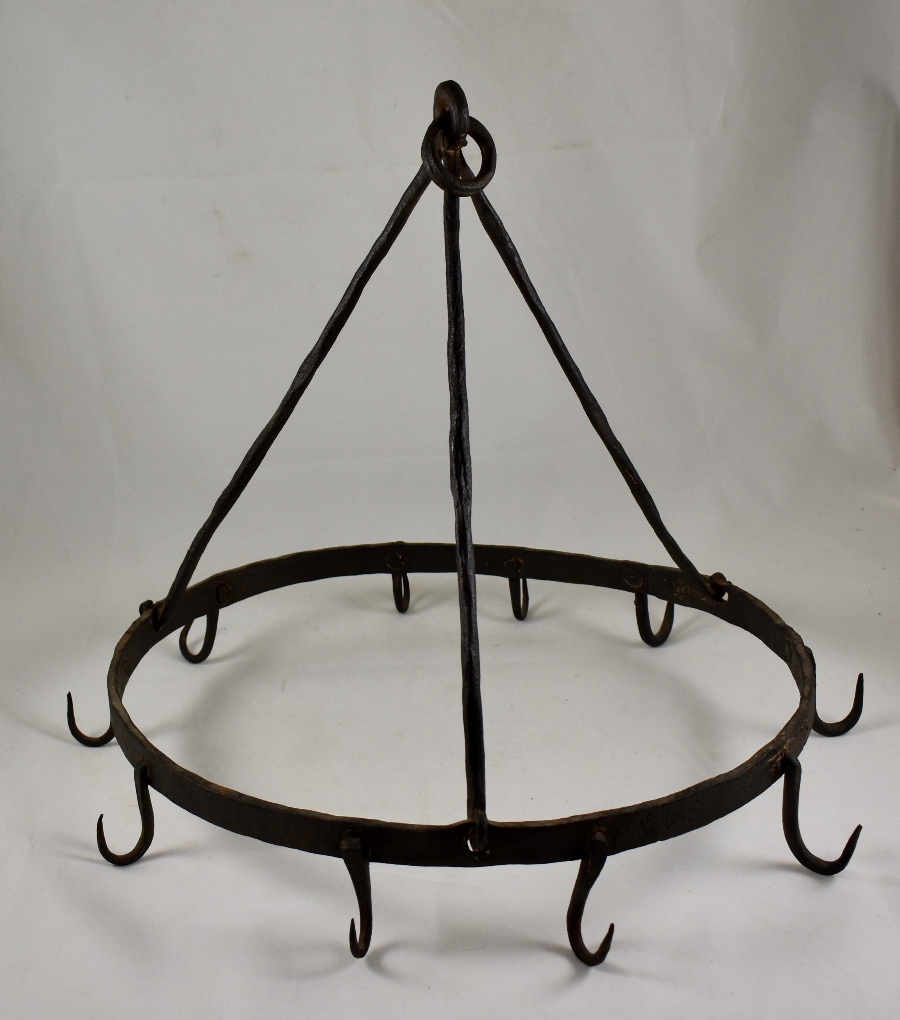A late 19th century American wrought iron butchers rack, an oval rack with ten hooks supported by three hanging rods terminating in a loop. 

Entirely hand-forged, rustic in feel, and perfect for the kitchen or garden. May be used as a pot and