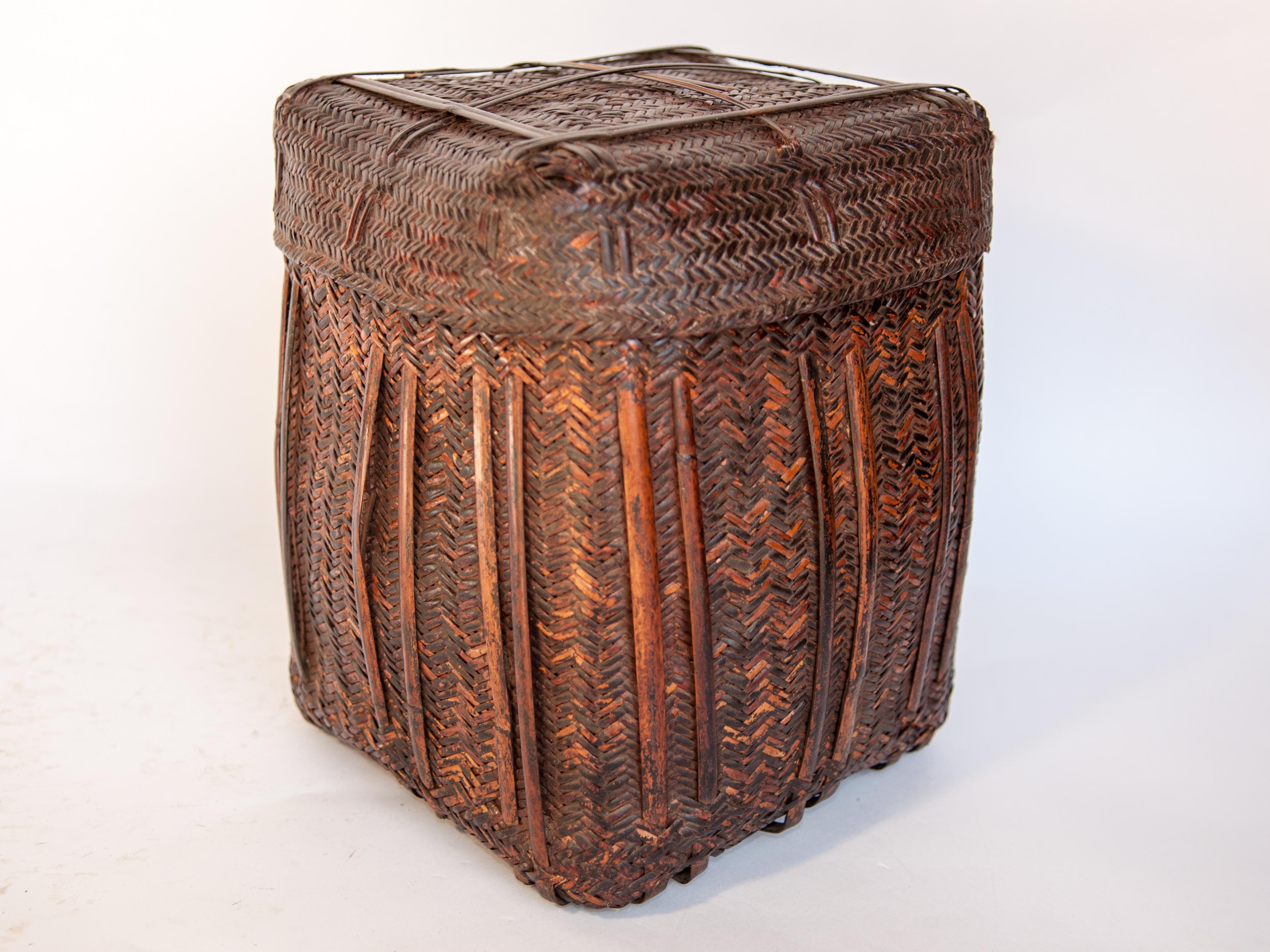 Rustic tribal storage basket with lid from the Tamang of Nepal, mid-20th century.
This rugged bamboo basket comes from the Himalayan Foothills of Nepal; and mirrors the raw beauty of the environment it inhabits and the hardiness of the people who
