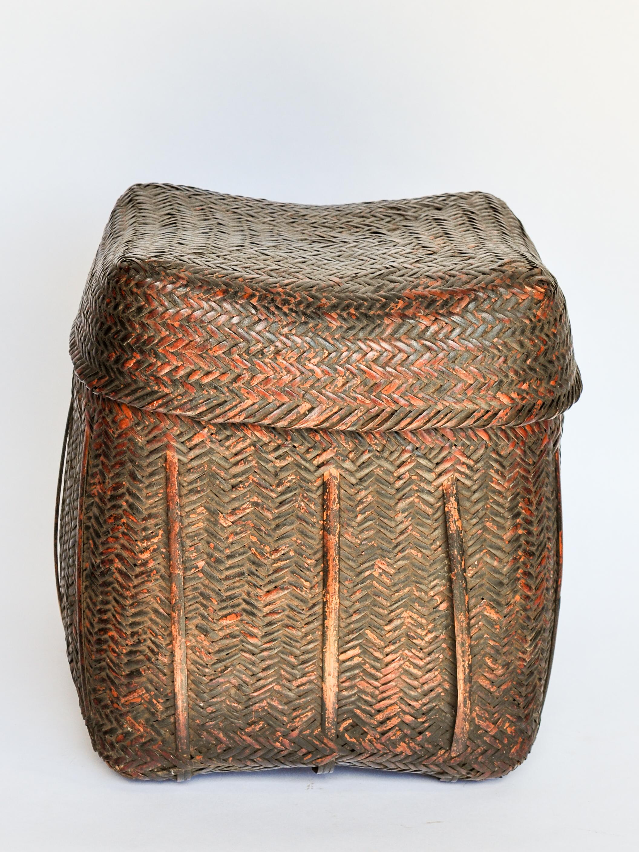 Rustic tribal storage basket with lid from the Tamang of Nepal, mid-20th century.
This rugged bamboo basket comes from the Himalayan Foothills of Nepal; and mirrors the raw beauty of the environment it inhabits and the hardiness of the people who