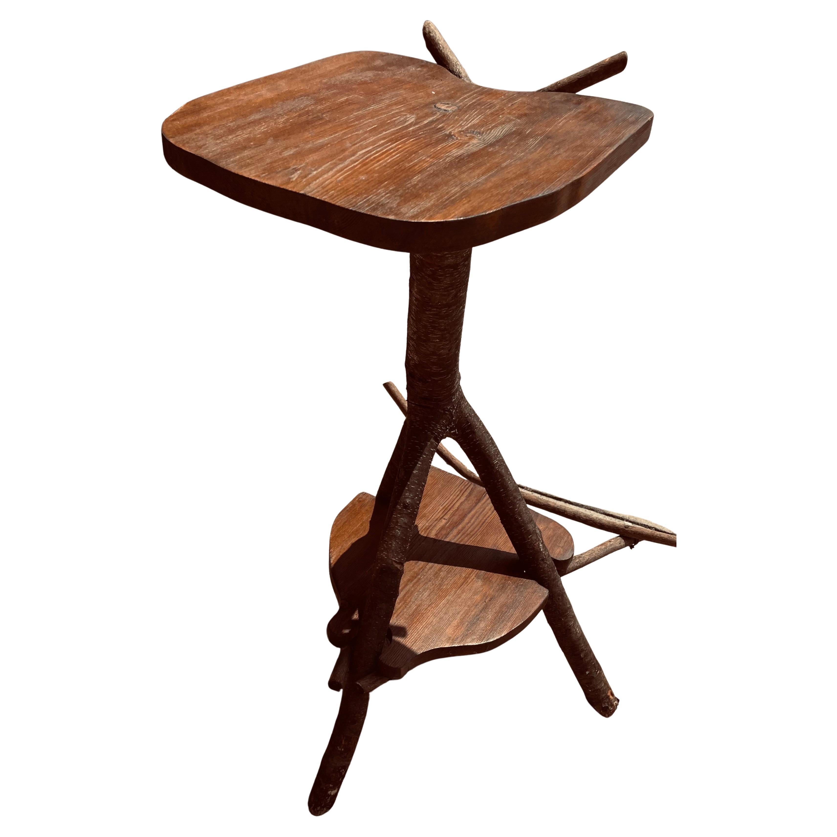 This is a very cool rustic twig guitar stand with a small table space on top and a lower shelf. It would be wonderful for a blue grass or country music artist to hold an extra instrument and a drink or other necessities. 

The top shelf is 28 inches