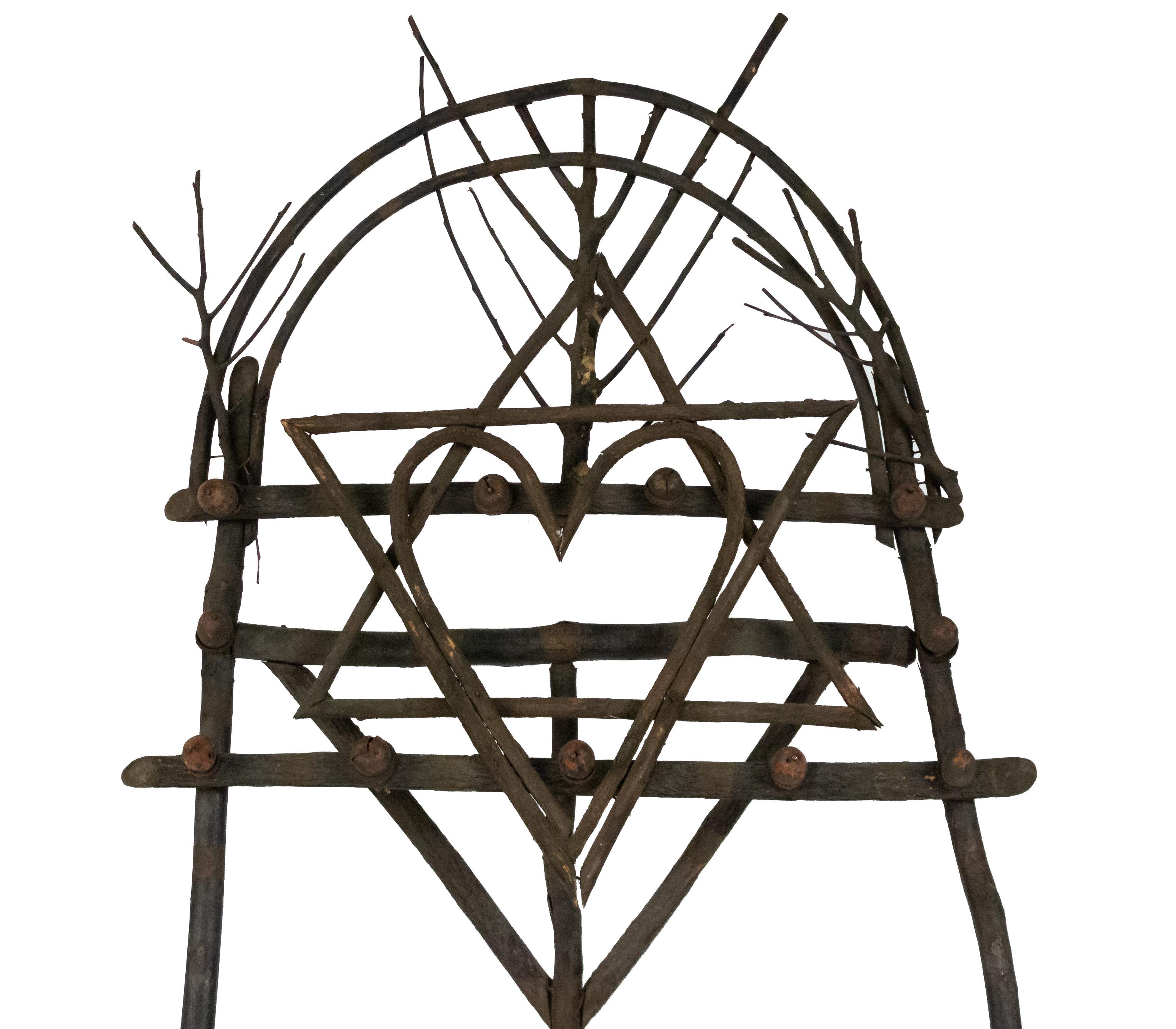 Rustic Adirondack natural twig wood easel with geometric shape designs and carved acorn trim.
    