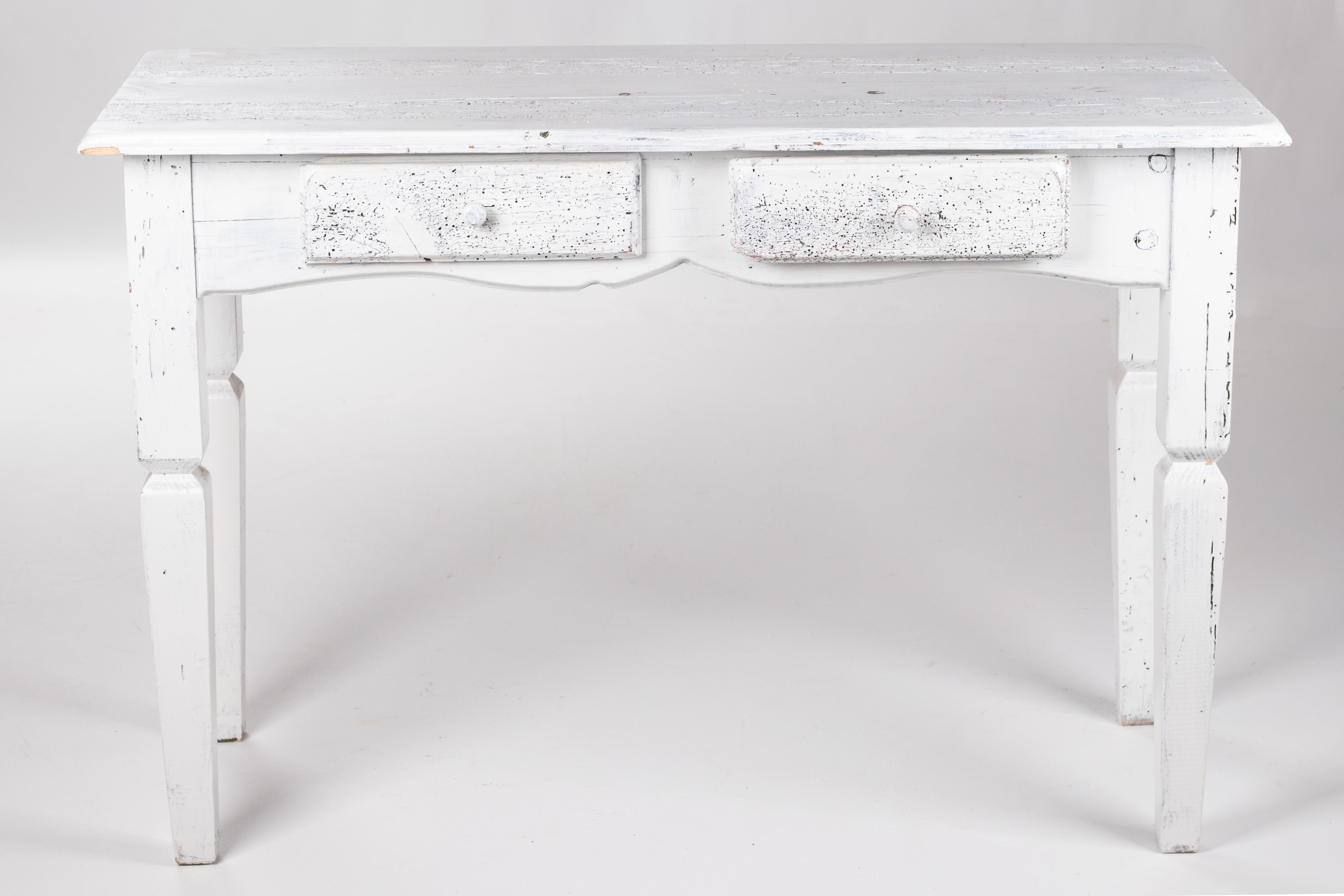 Rustic two-drawer French wooden table painted in white.