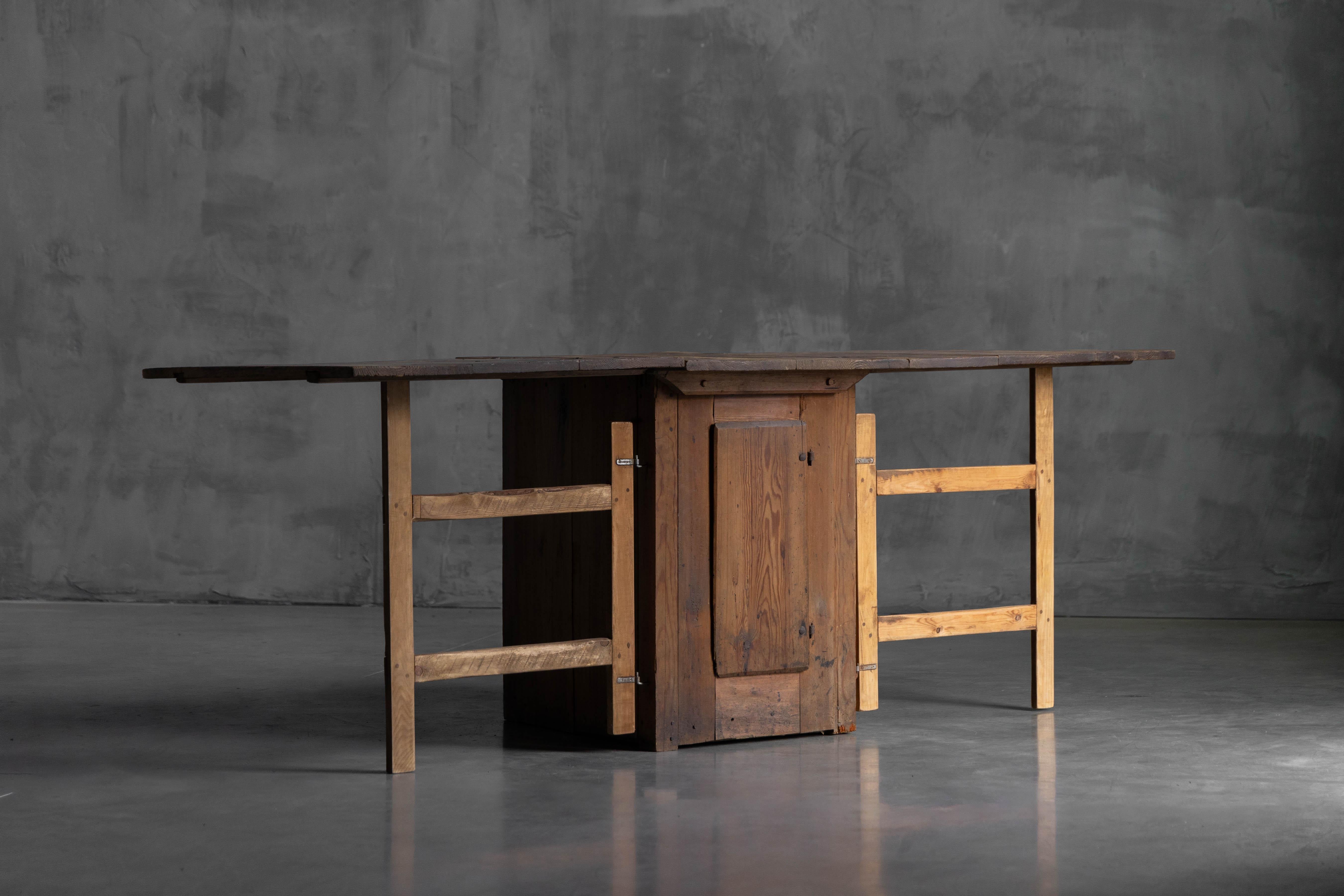 This authentic vernacular worktable is hand-built from solid wood with a naturally aged patina and features a practical drop-leaf design that adapts to your needs. Both leaves open for a generous work surface, a single leaf extended for partial use,