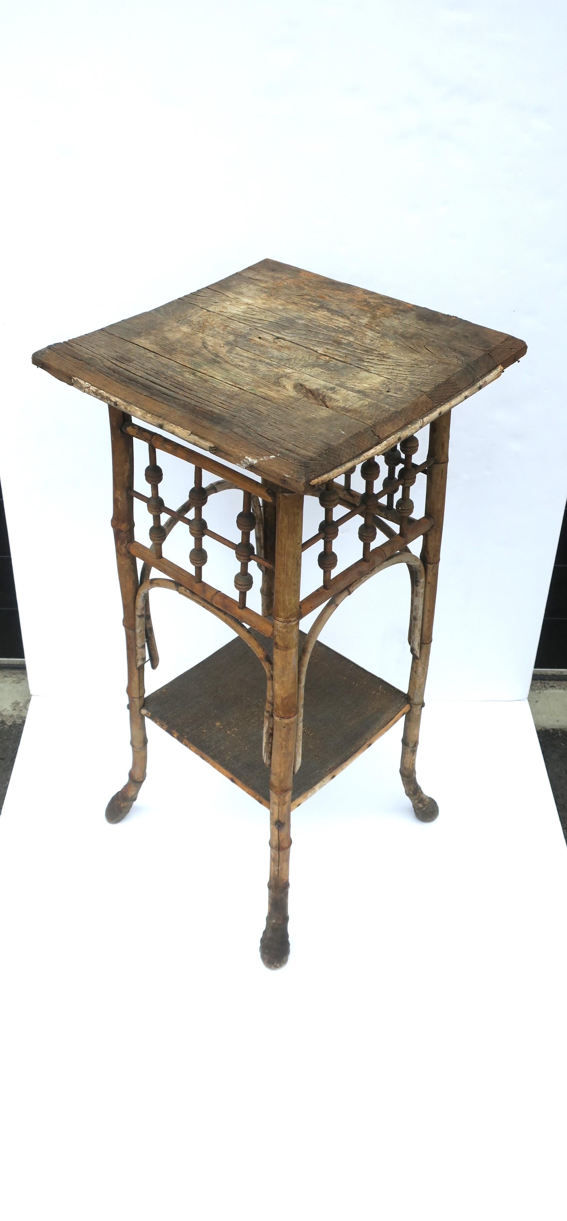 A rustic and beautifully weathered hand-crafted wood and bamboo side/end/accent table with lower shelf, Victorian, circa early-20th century. A versatile table, sound and stable. Dimensions: 14.25