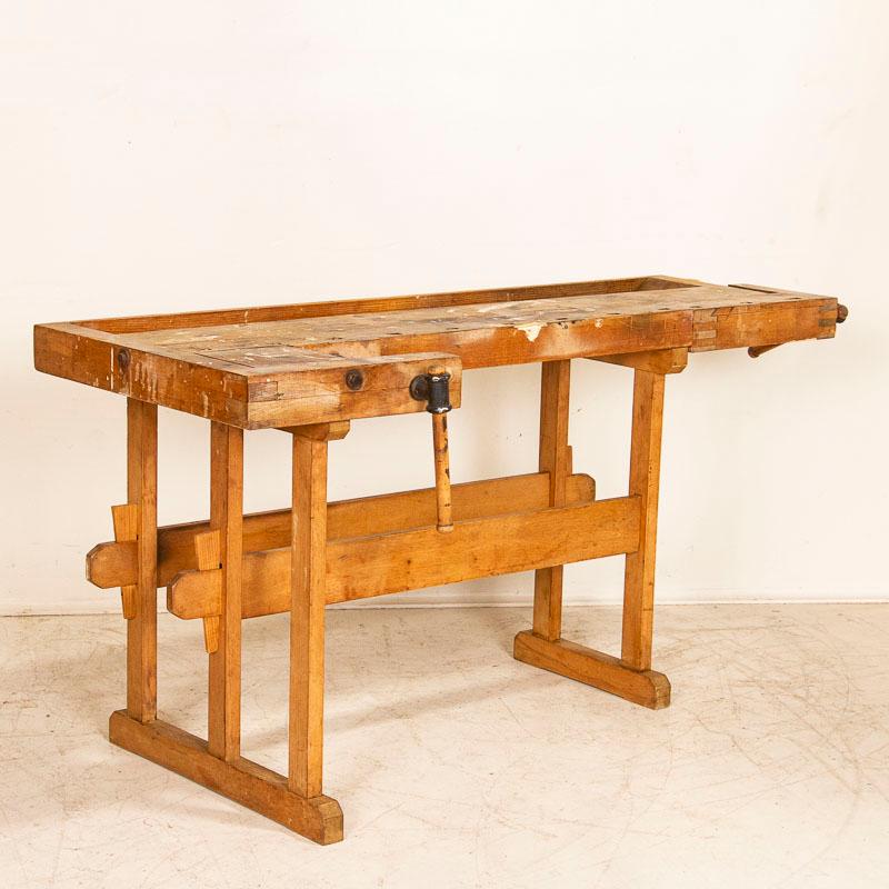 Rustic antique carpenters’ workbench, showing lots of character after years of traditional use. Please examine the close up photos to appreciate the patina of the pine base and hardwood top. Every gouge, scratch, and paint stain reveal generations