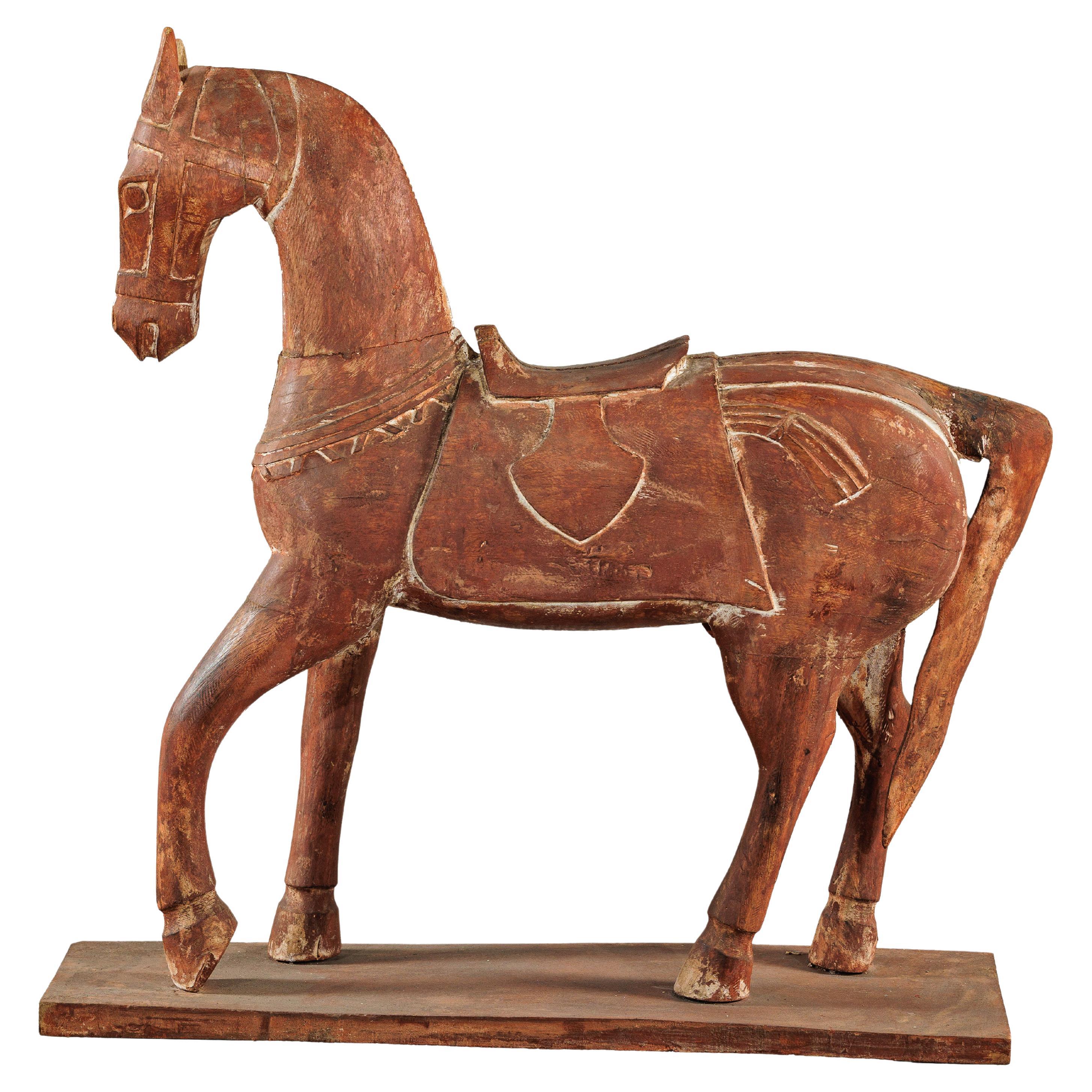 Caballo rústico vintage de madera tallada con silla de montar sobre soporte, circa 1950