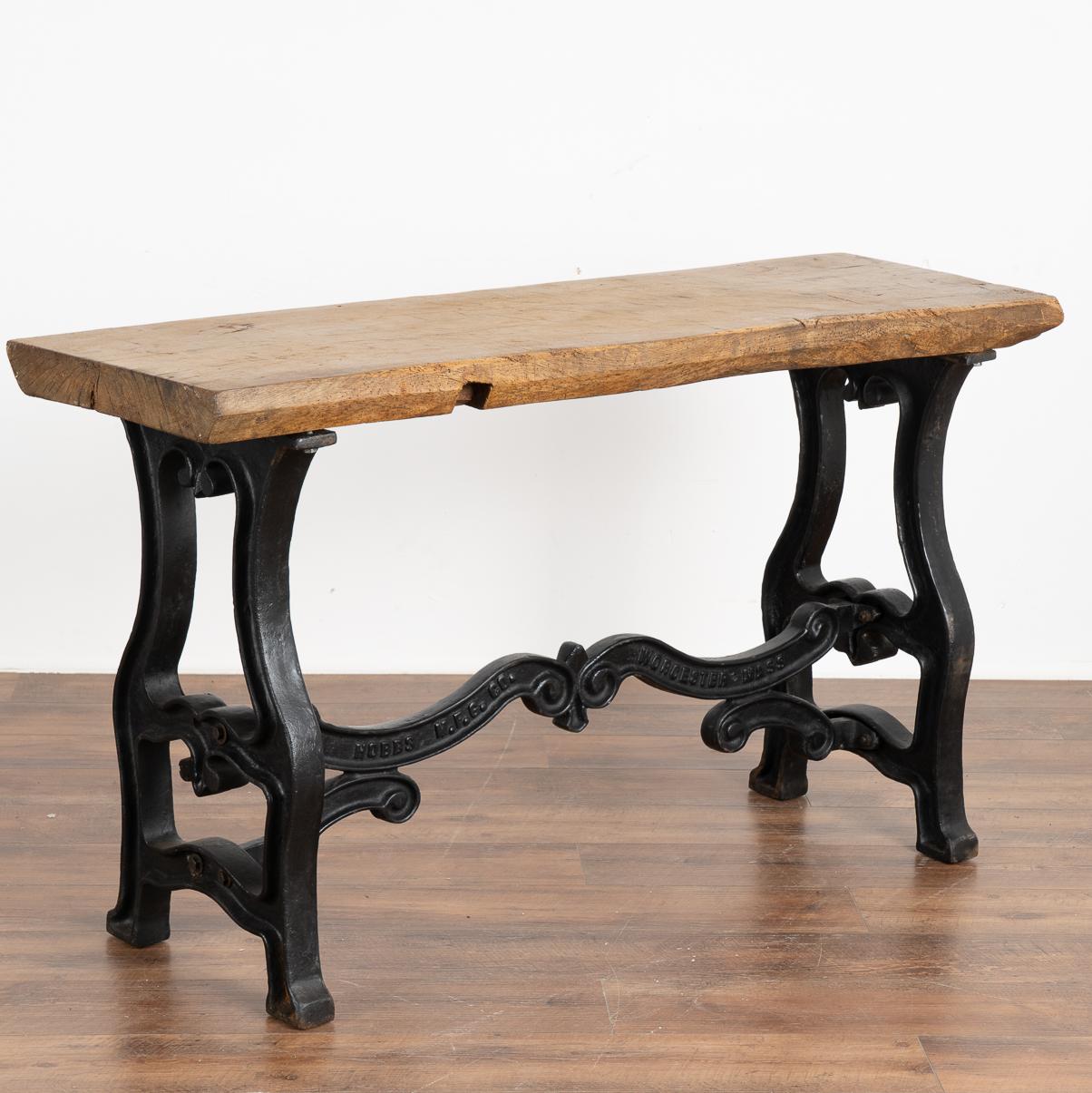 This impressive console table draws you to reach out and touch it due to it's thick hard wood slab top that originally served as a work table.
The (new) cast iron legs have a vintage look adding stability and an industrial look.
The rustic appeal
