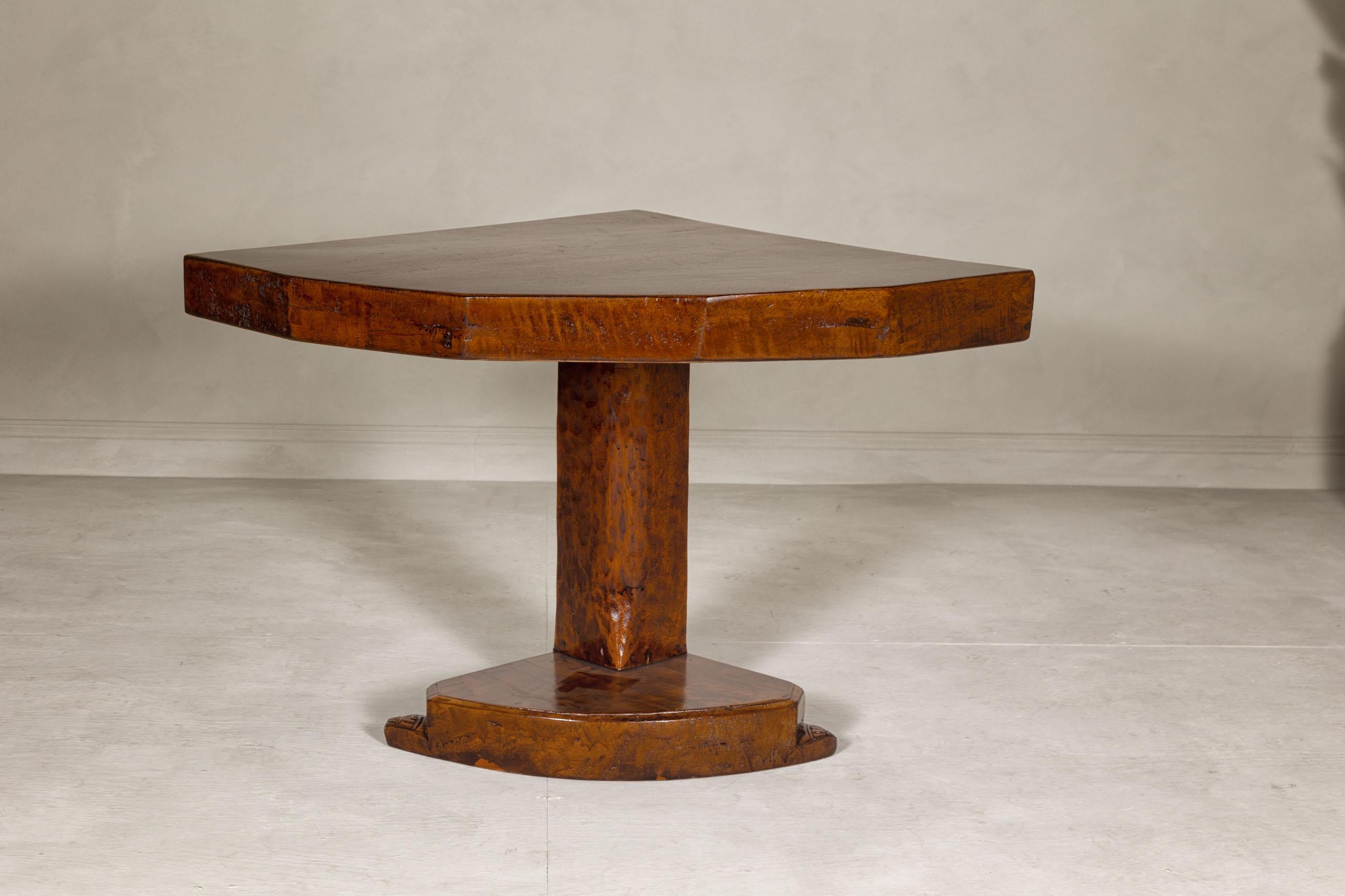 An unusual vintage corner demi-lune table from the mid 20th century with delicately carved base. Embrace the subtle elegance of this mid-20th-century vintage corner demi-lune table, a piece where functionality meets decorative finesse.