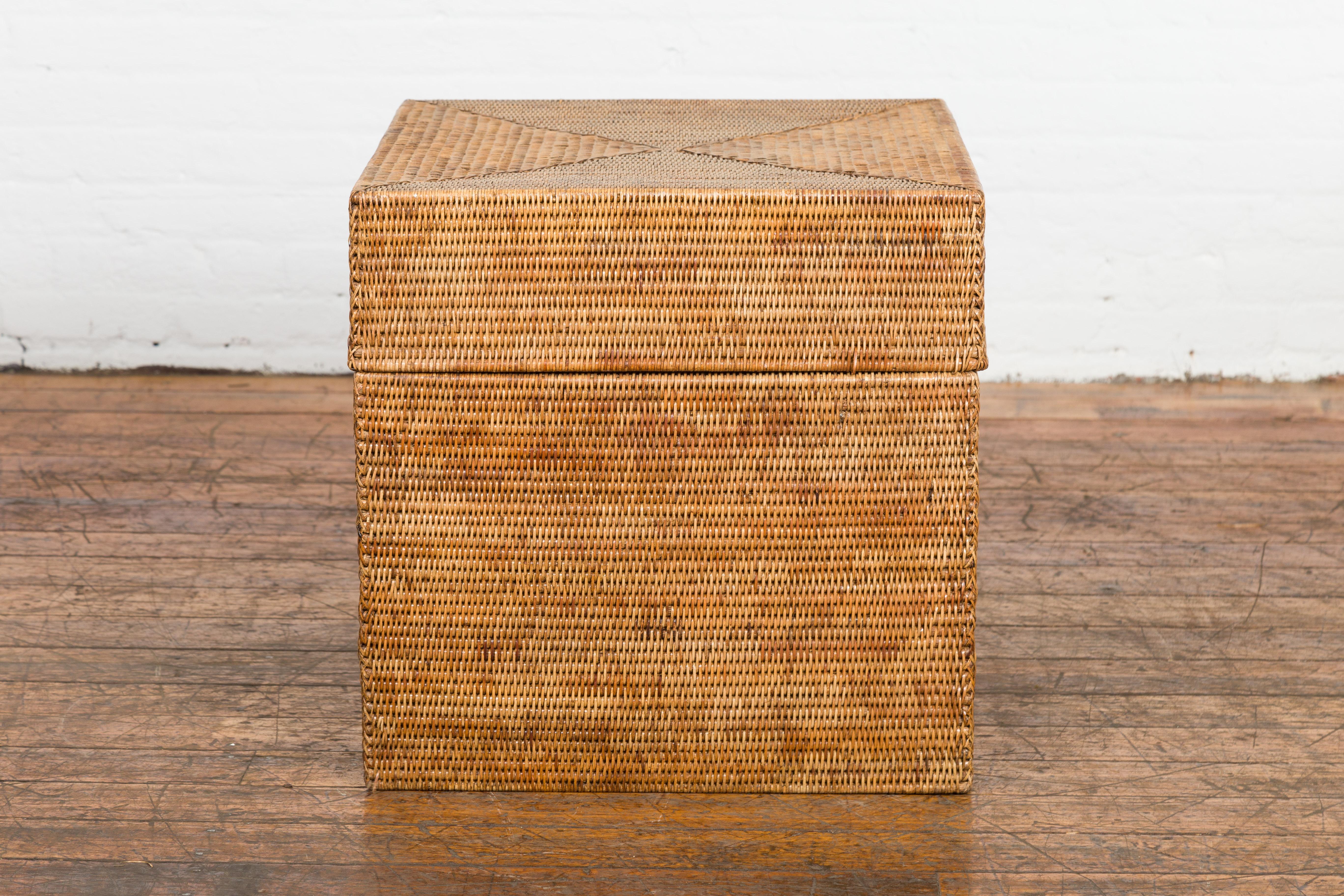 A rustic vintage Thai Country style woven rattan lidded box from the mid 20th century lidded, perfect to be used as a storage or toy box. Embrace a rustic aesthetic with this vintage Thai Country-style woven rattan lidded box from the mid-20th