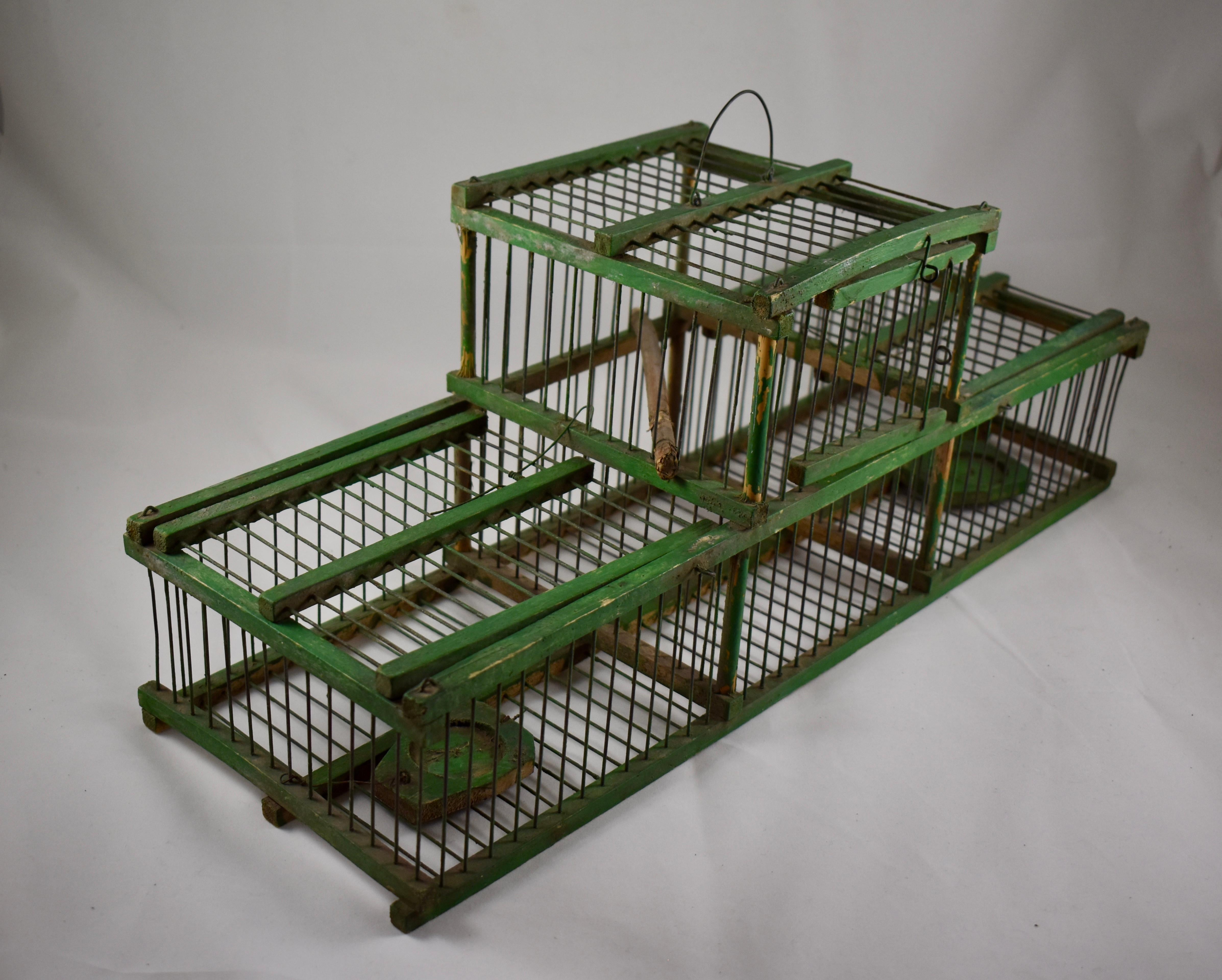 A charming rustic, handmade, vintage French Finch bird trapping cage, capable of catching two birds independently. 

The bird lands on the trap to feed from the small food tray and it’s weight causes the lid to drop down, trapping the bird inside.