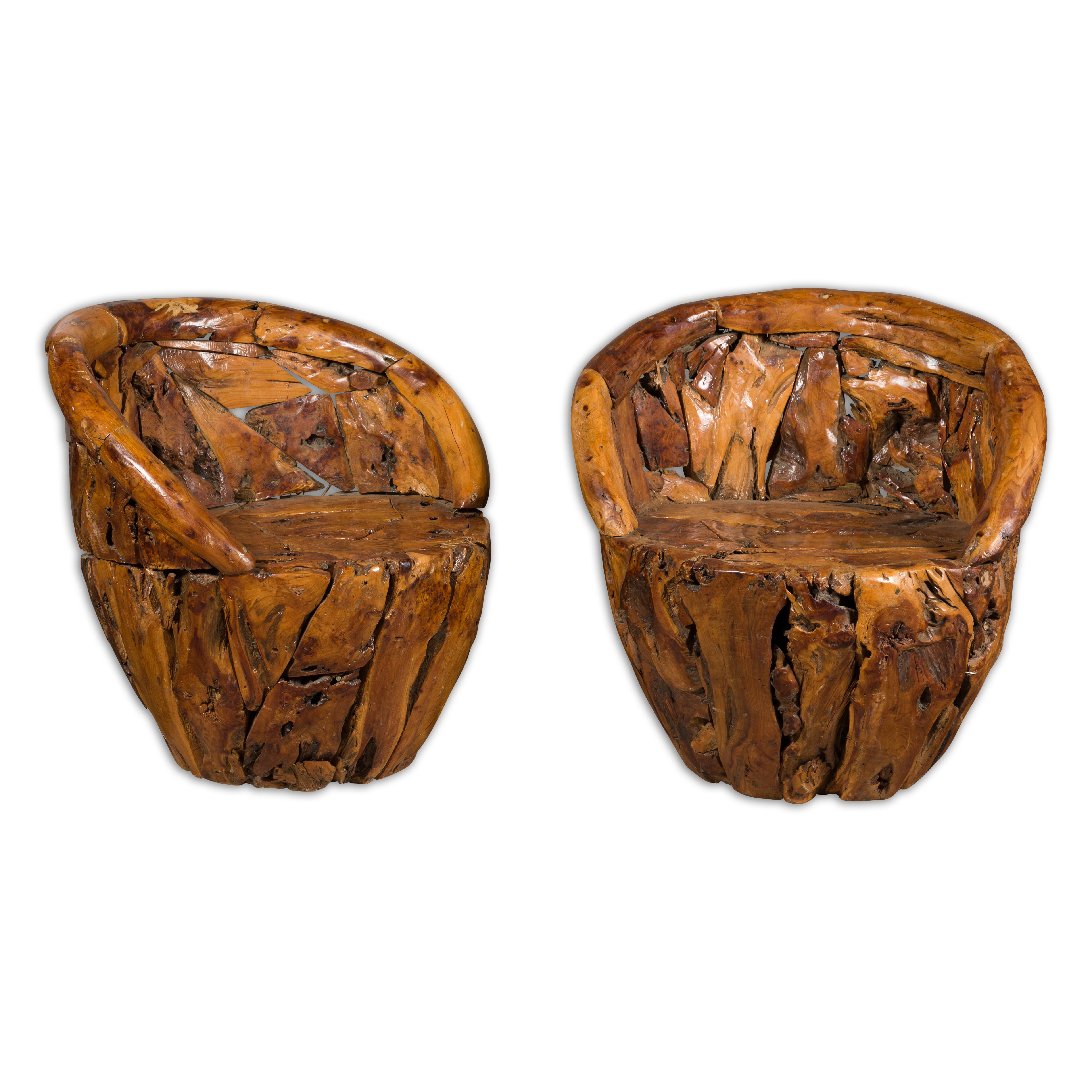 A vintage pair of American root wood armchairs with wraparound backs and rustic character. Experience the raw allure of nature and craftsmanship with this pair of vintage American root wood armchairs. Imbued with a rich history and character, these