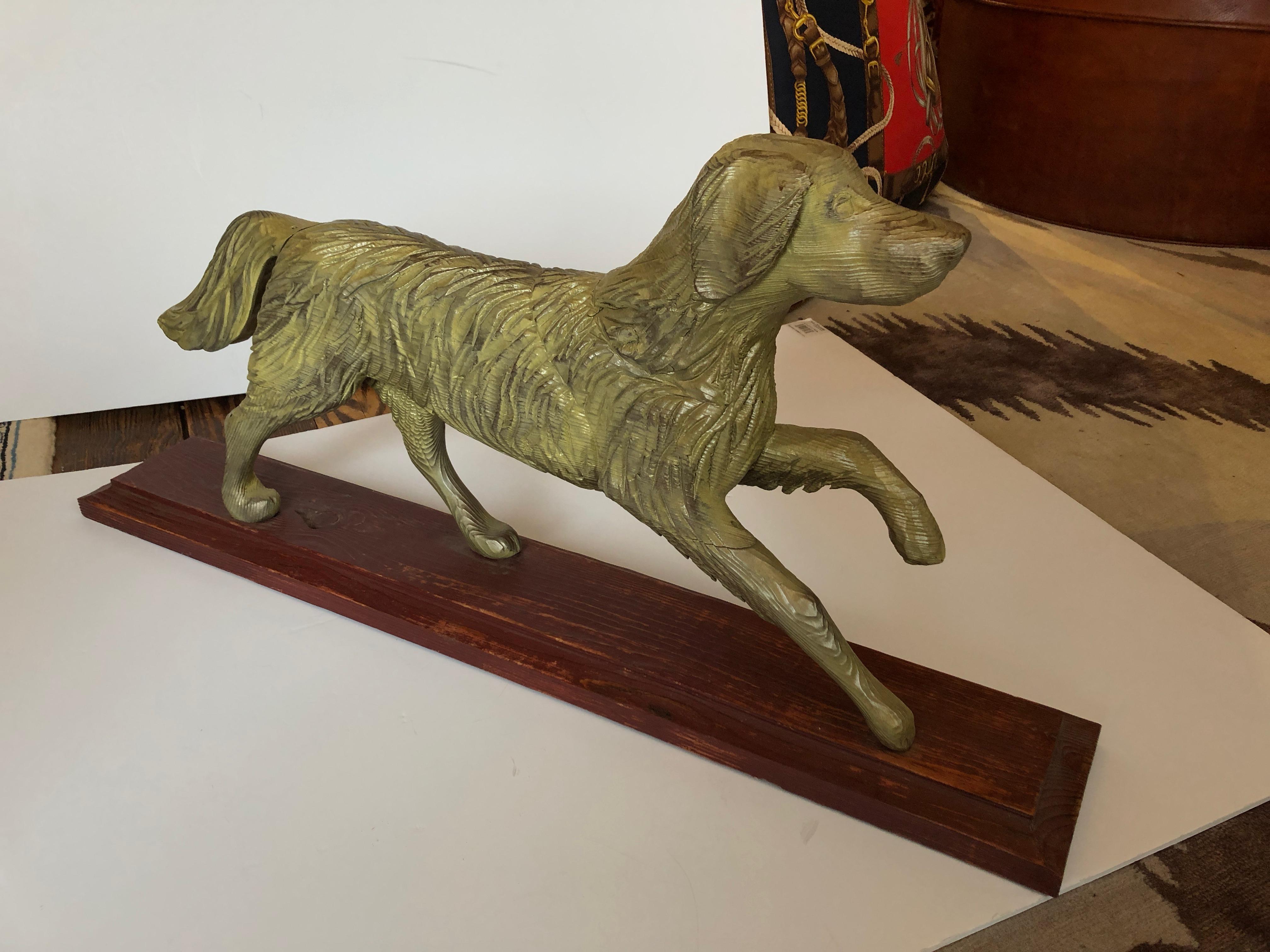 Wonderful rustic carved wood sculpture of a retriever in mid stride, mounted on red barn wood stand.