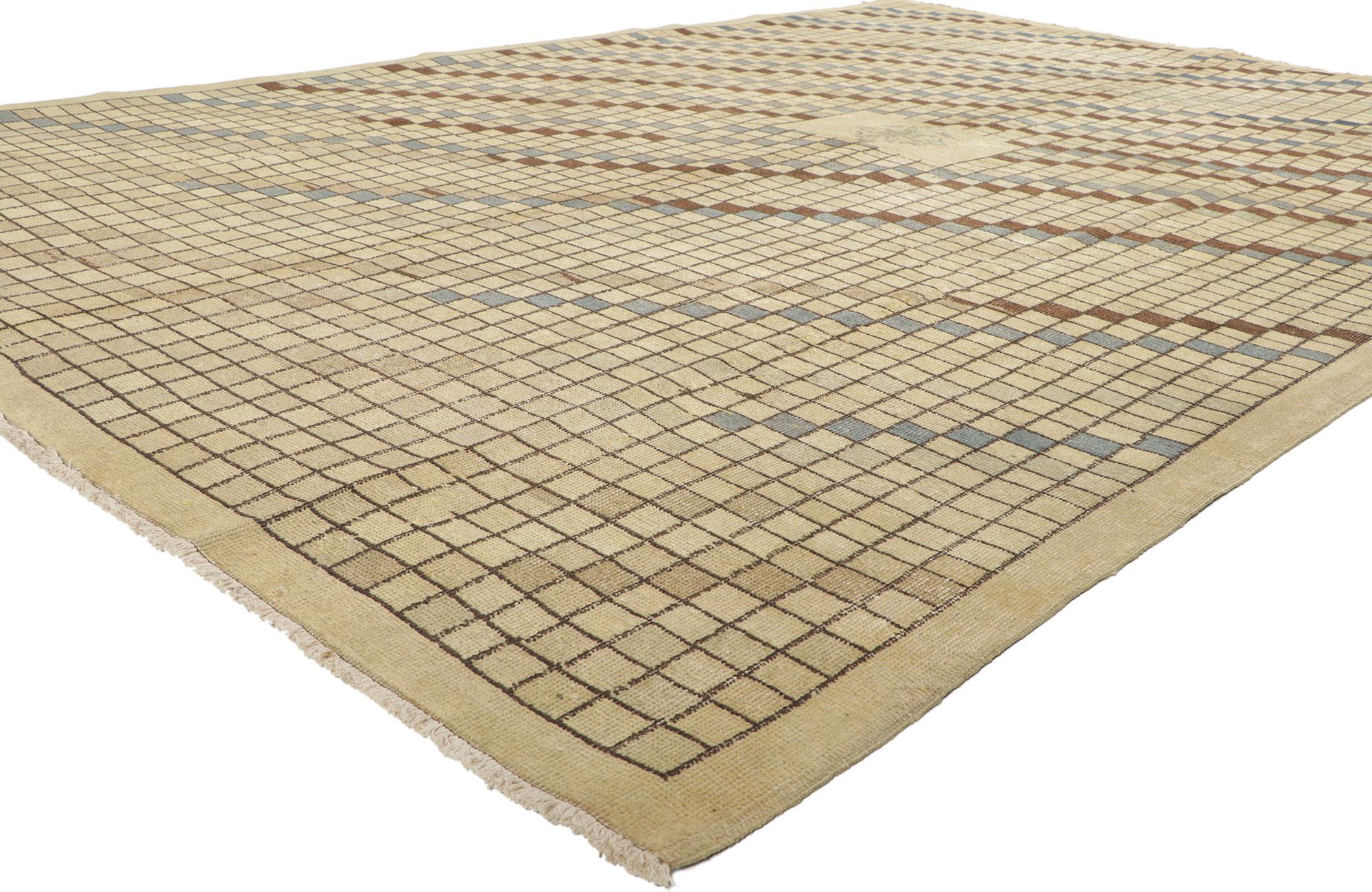 52139 Vintage Turkish Sivas Rug, 06'11 x 10'03.
This hand-knotted wool distressed vintage Turkish Sivas rug with Modern rustic style features an all-over square pattern. The modest field tastefully complements the simple beige border. The intrinsic