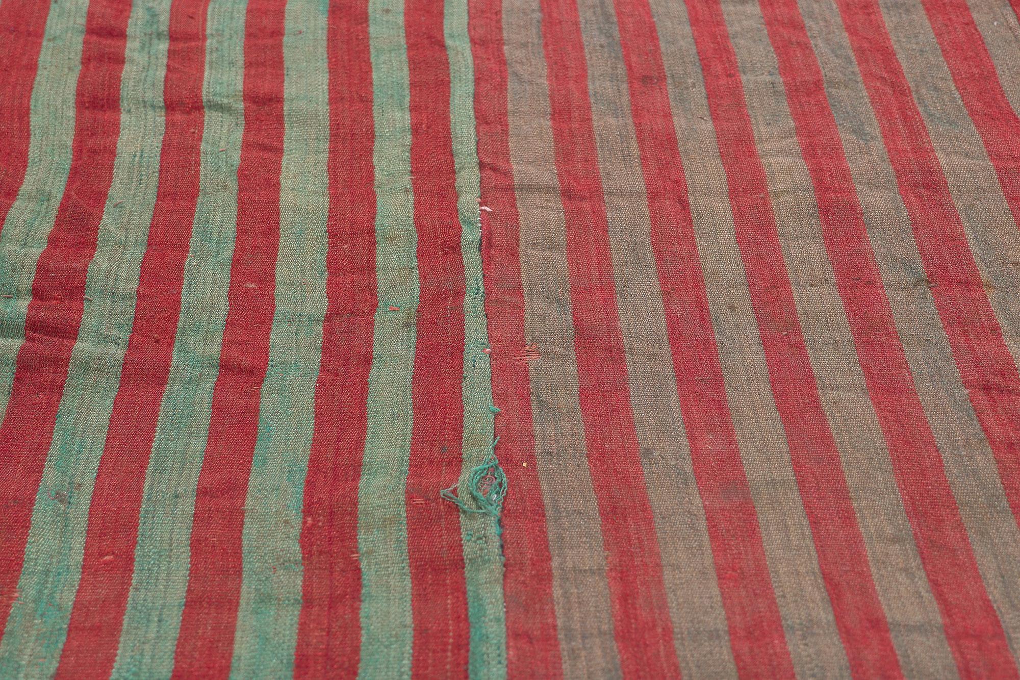 Rustic Vintage Turkish Striped Kilim Rug, Weathered Charm Meets Rugged Beauty In Distressed Condition For Sale In Dallas, TX