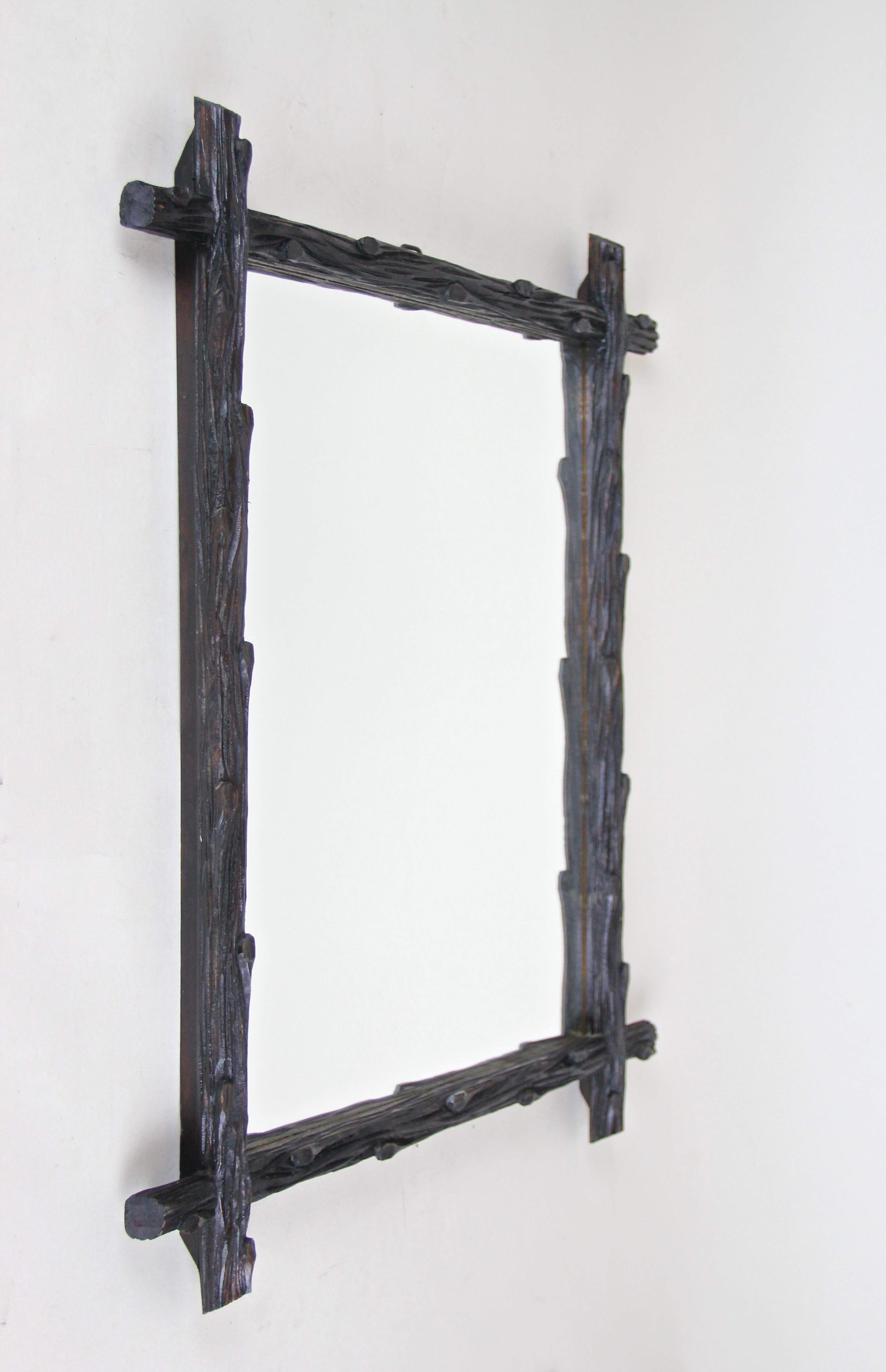 Beautiful rustic wooden black forest wall mirror from Austria, circa 1870. This so-called 