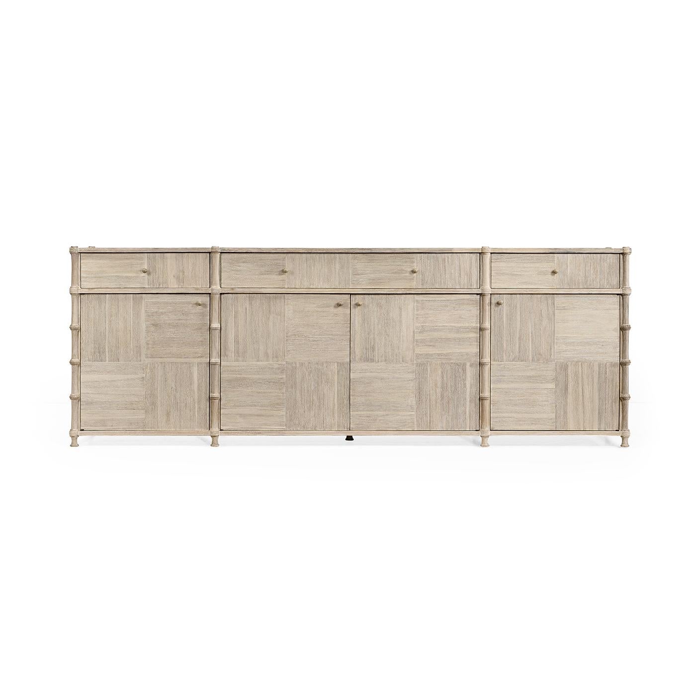 Crafted from a patchwork of acacia wood, its intricate parquet-inspired design brings warmth and depth, while the washed acacia finish enhances its light, airy aesthetic. This generously sized buffet offers both beauty and function, with reeded