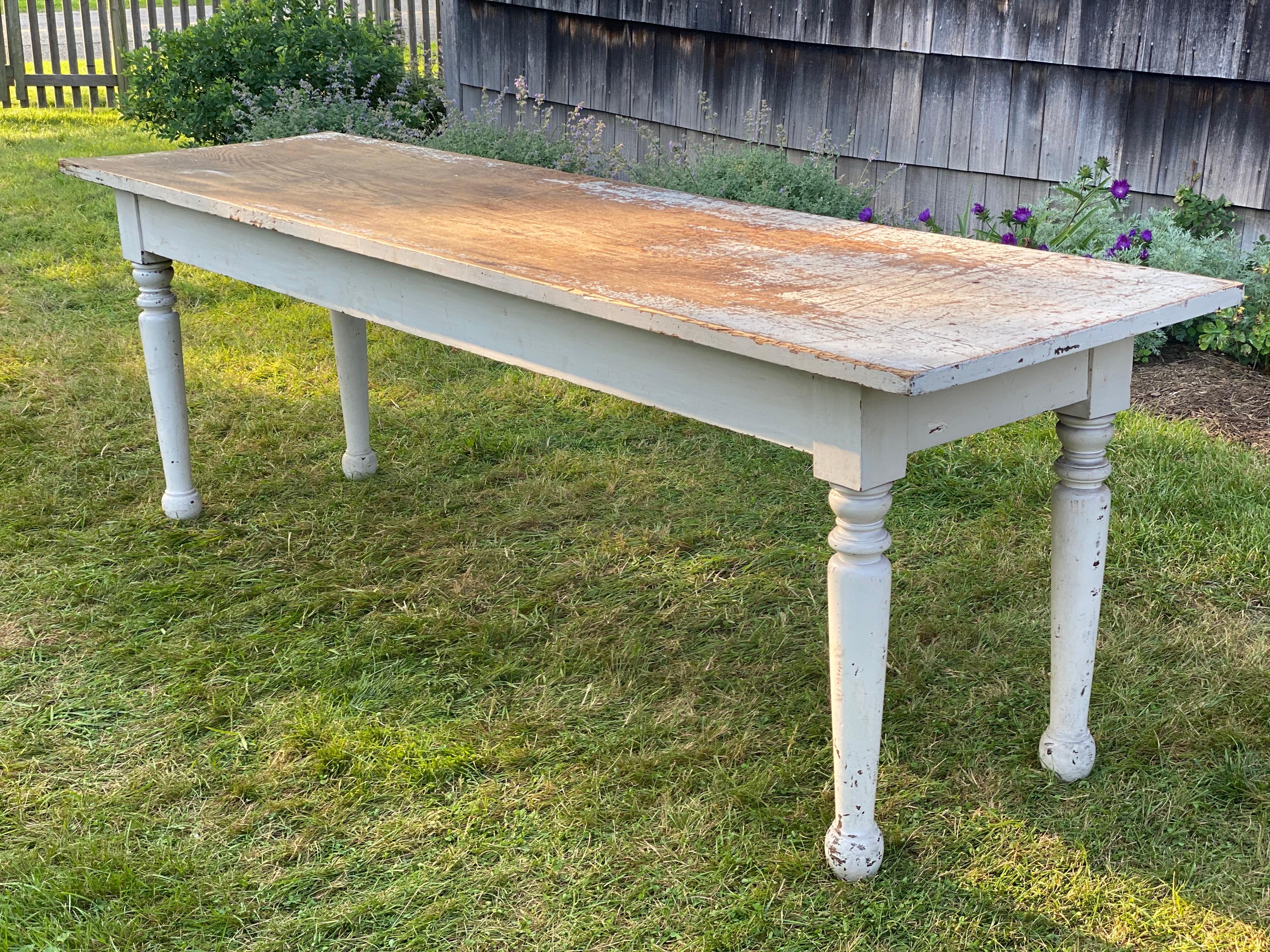 Rustic white painted long narrow farm table, 20th Century
Turned legs and a rustic worn top. This table has a great look and patina. White paint is mainly worn from the top but also expected wear on legs as well. Good stable condition.

Measures: