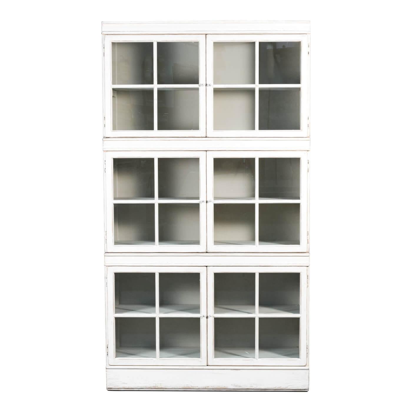 Rustic windowpane bookcase display cabinet in a distressed white painted finish. A beautiful and functional piece that has six glass front doors that open to separate compartments. The interior is painted in a soft grey color. 

Made of reclaimed