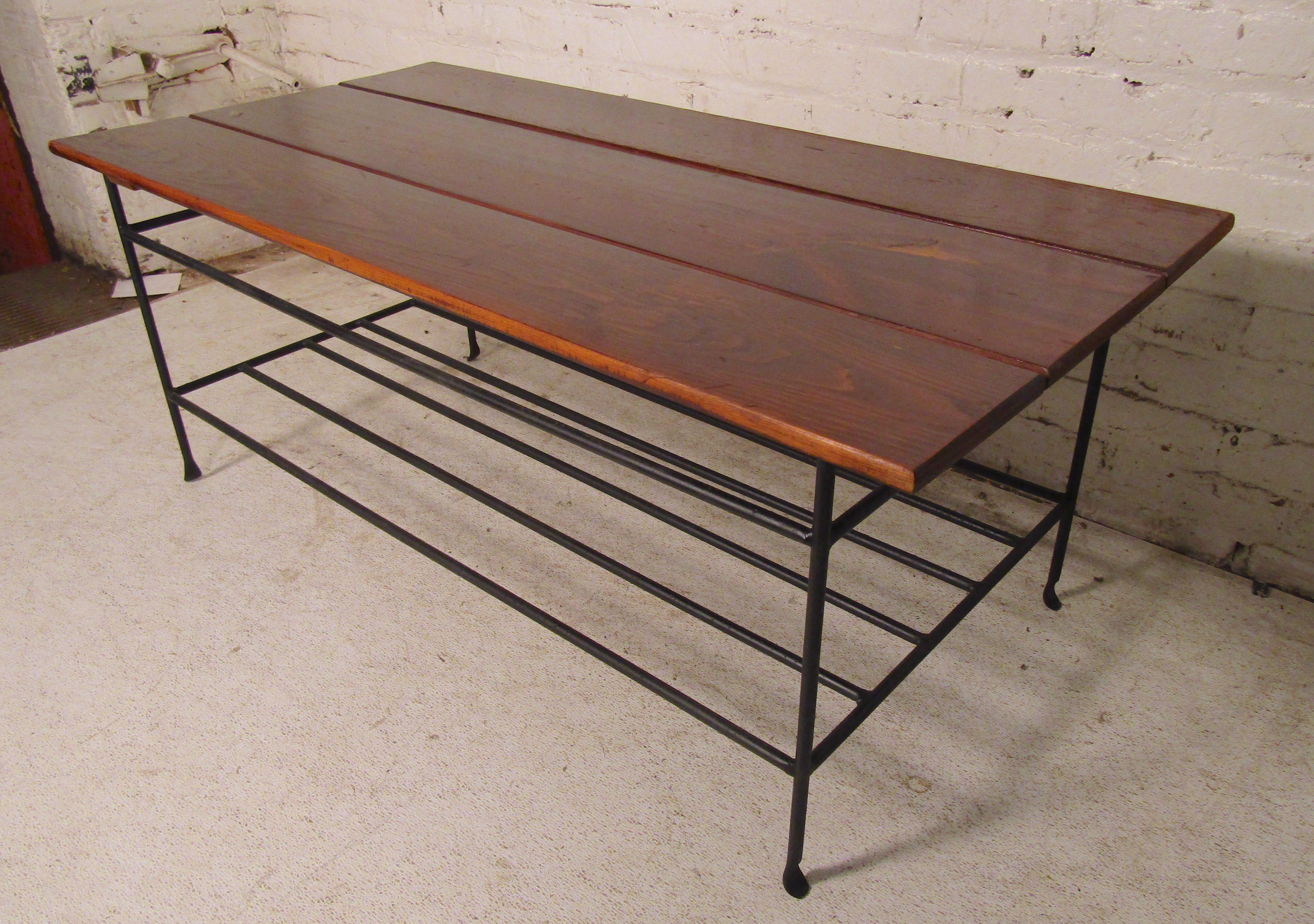 Vintage slat table with wrought iron frame and magazine shelf.
(Please confirm item location - NY or NJ - with dealer).
   