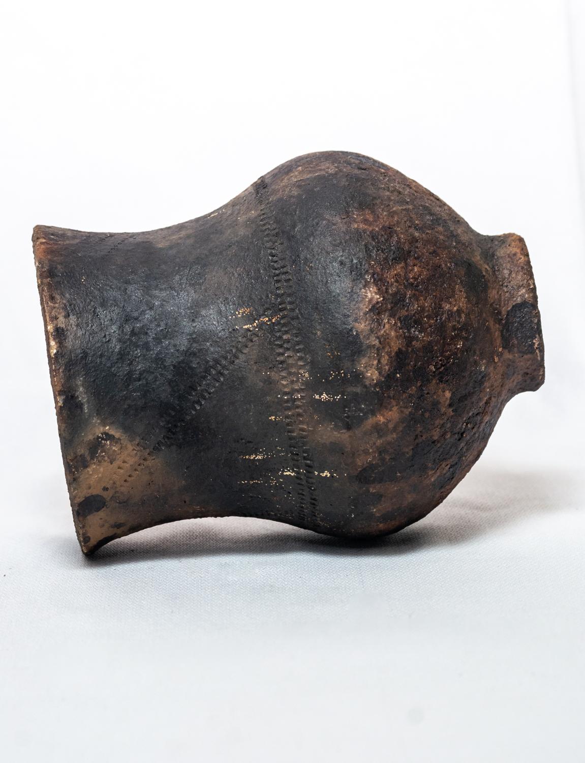 Add a touch of rustic sophistication to your decor with our Rustic Wood-Ash Fired Vase, crafted from locally sourced clay. This beautiful vase is created using a traditional wood-ash firing process, where layers of ash are applied to the clay before
