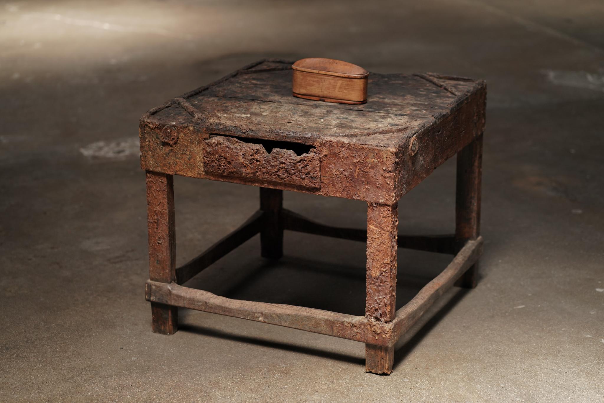 A rustic wood table from Japan, marked by a rich patina and a single center drawer. Its aged surface and straightforward form give it the defined character of another time.