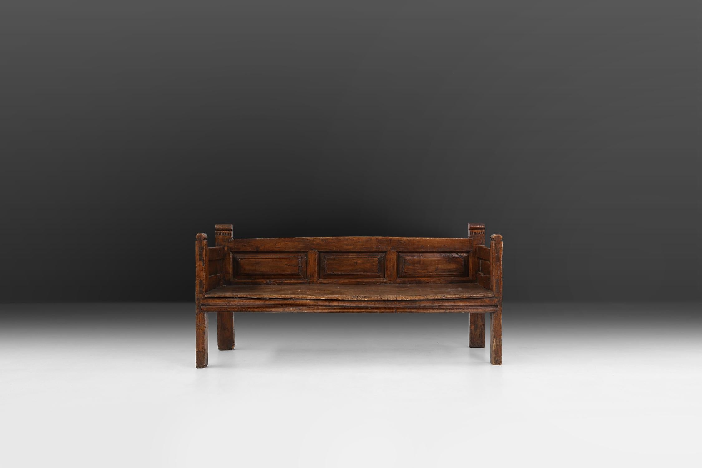 French handmade bench made around 1800. This three seater has very beautiful sculpted details in the solid wood. A beautiful patina on the wood creates a very rustic and Wabi-Sabi look.
