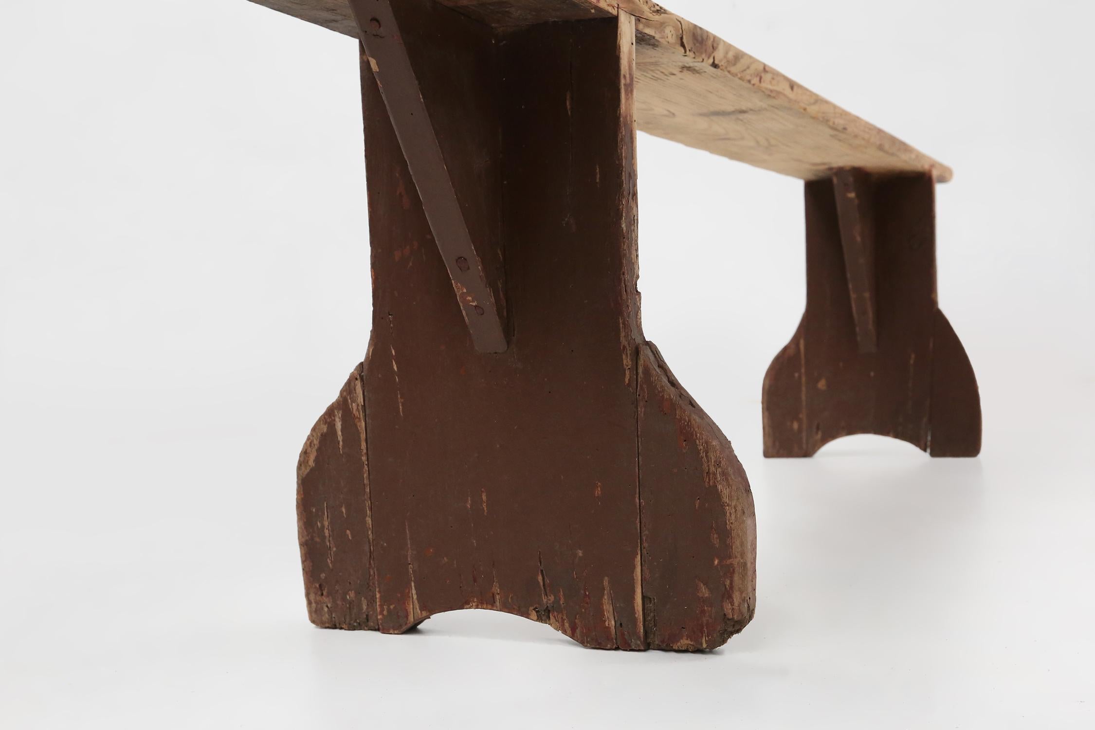 Wood Rustic wooden bench in with brown painted feet, France ca. 1890 For Sale