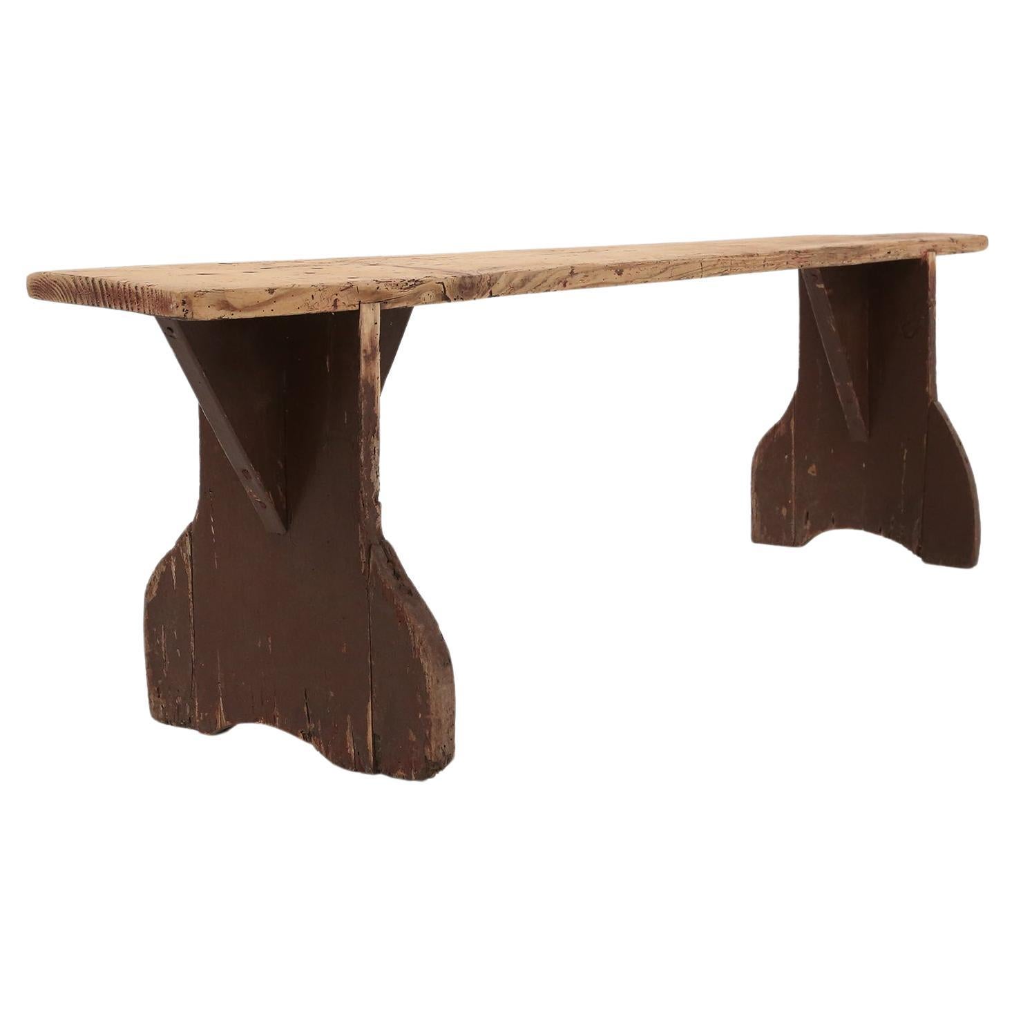 Rustic wooden bench in with brown painted feet, France ca. 1890 For Sale