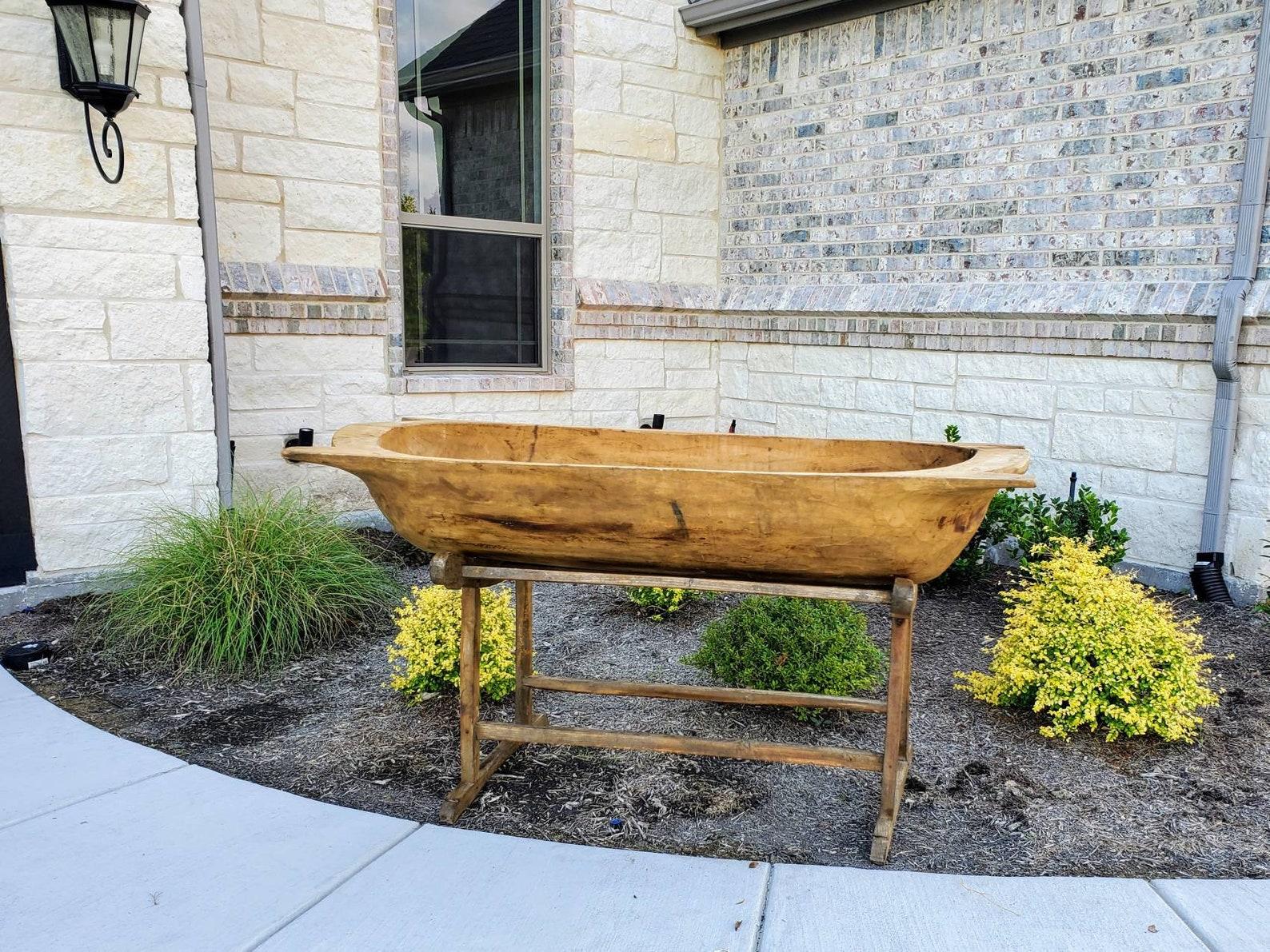 Used for multi-family communal and occasionally industrial baking, this huge fruitwood trough was hand-crafted from a single split log, its rich antique brown wood color and tones showing off the tool marks on its hand-hewn interior. A few marks,