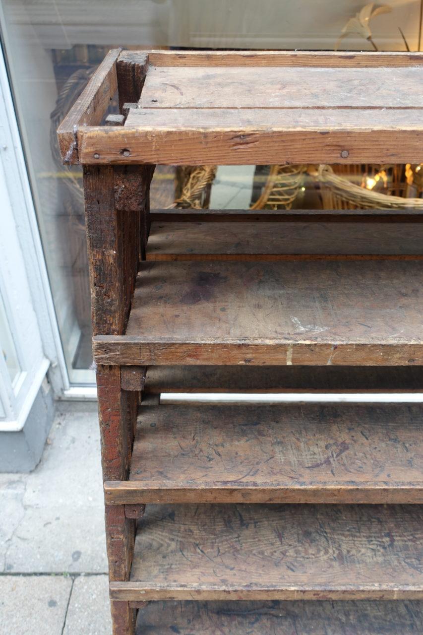 Vintage and rustic French industrial shelving trolley, in beautiful dark wood from the 1920s. Super patina. Provenance – a shoe manufacturer in the South of France, where with its wheels it could be a versatile and moveable piece of furniture. Its