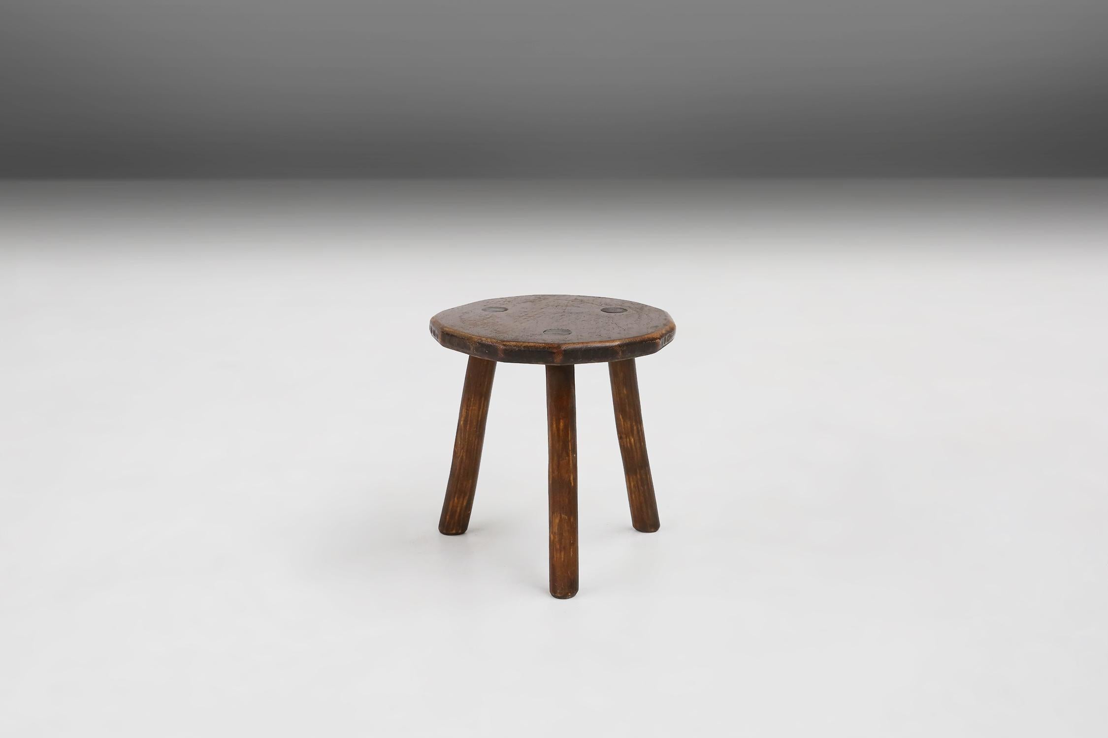 Round rustic wooden stool with great patina made around 1900.
Some nice details on the top where the legs are attached to the seat.

This rustic round stool is a simple and charming piece of furniture that can add character and warmth to any