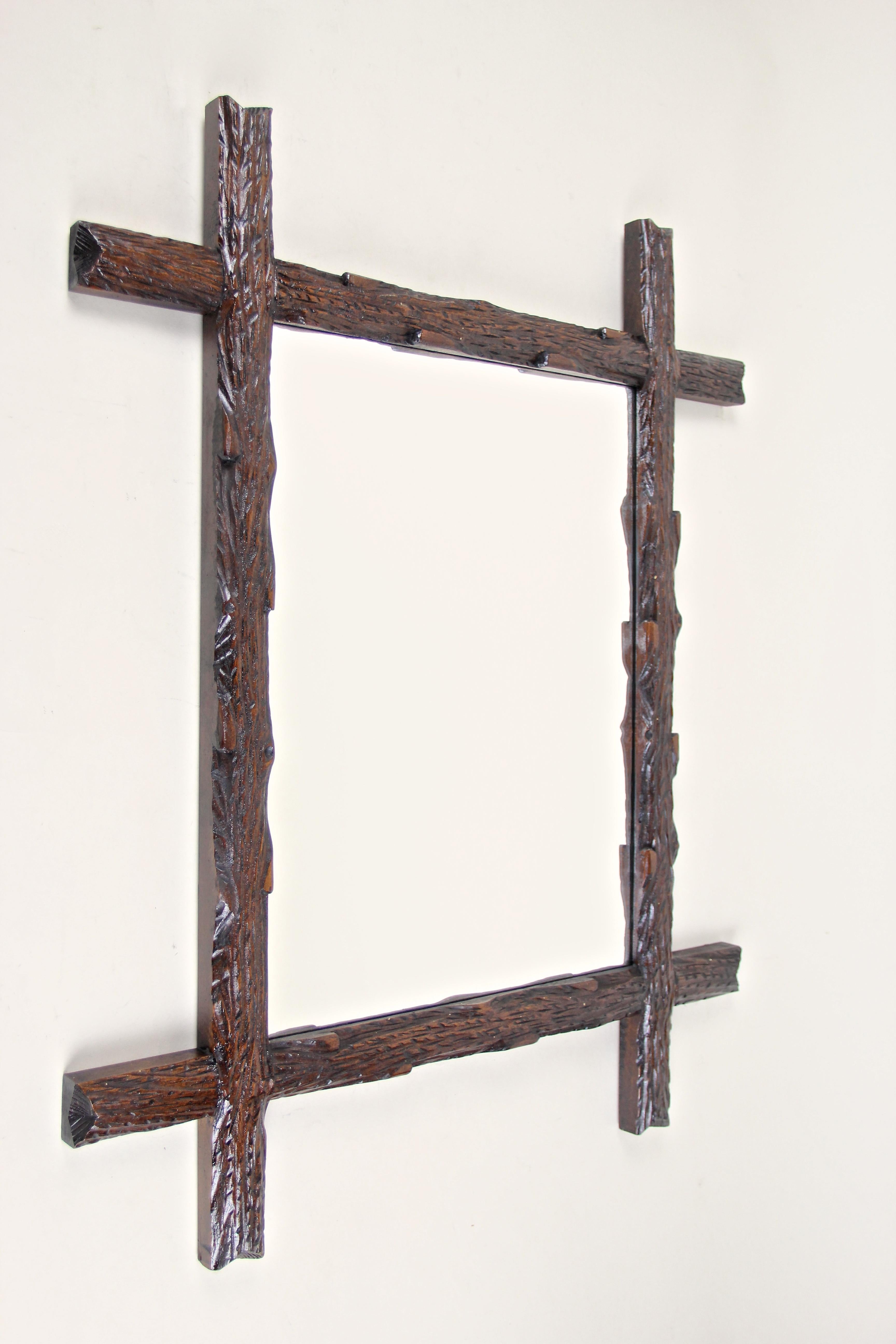 Great rustic wooden wall mirror in our high demanded Black Forest mirror collection. From Austria circa 1880 comes this unique artfully hand carved frame with protruding corners and impresses with its rural 