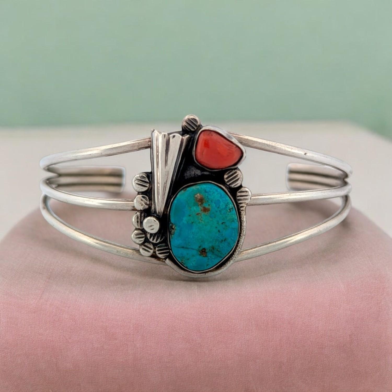 Vintage handmade Navajo sterling silver cuff bracelet with Morenci turquoise and deep red coral cabochons. Cuff features a three wire design. Piece is unsigned. Accompanying provenance paperwork notes it was purchased from Rd Runner Arts Crafts in