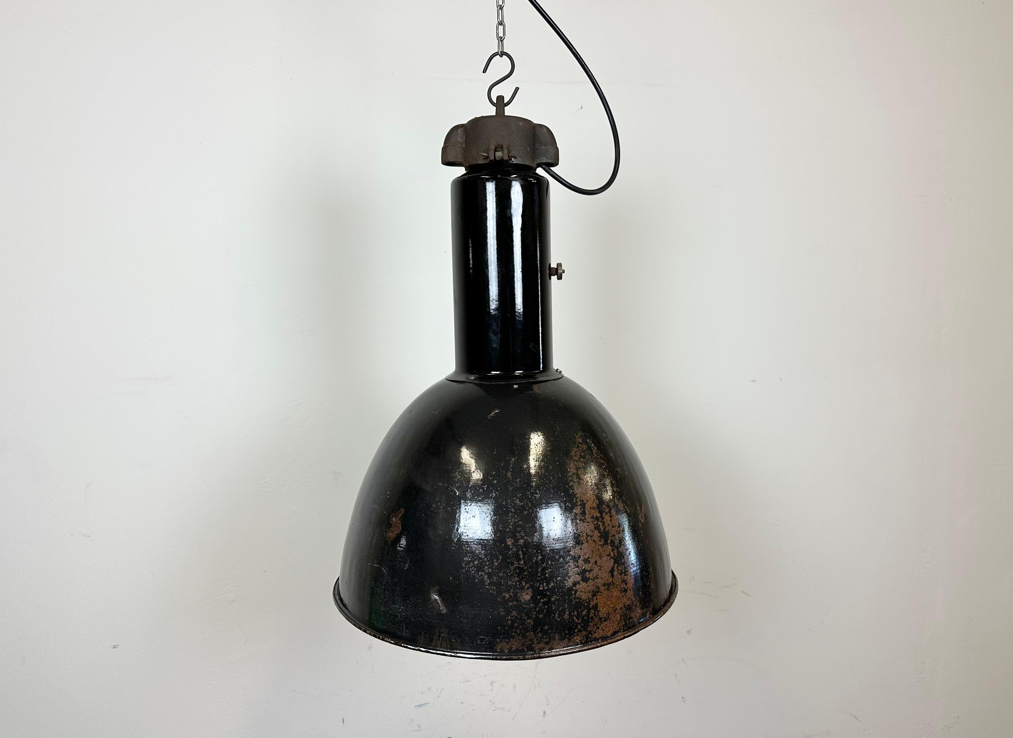 Industrial black enamel pendant lamp made by Elektrosvit in former Czechoslovakia during the 1930s -1970s. Designed in the period of Bauhaus. White enamel inside the shade. Cast iron top. New porcelain socket requires standard  E 27/ E 26