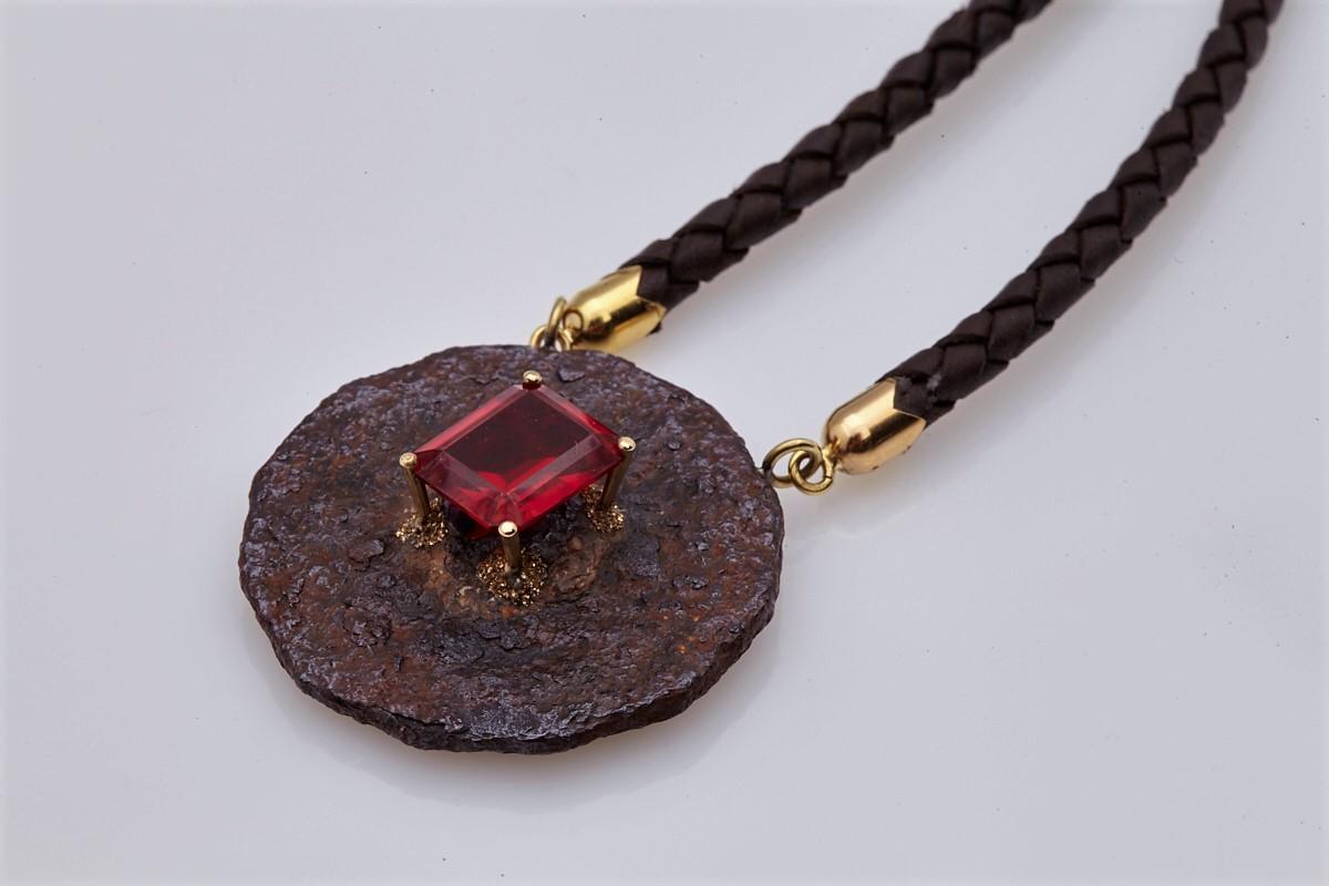 Unique, different, beautiful! A necklace made with lots of inspiration from the designer! Rusty object, vernail synthetic ruby, leather and 18Kt yellow gold combined all together they give a really exceptional artistic piece of jewelry that will