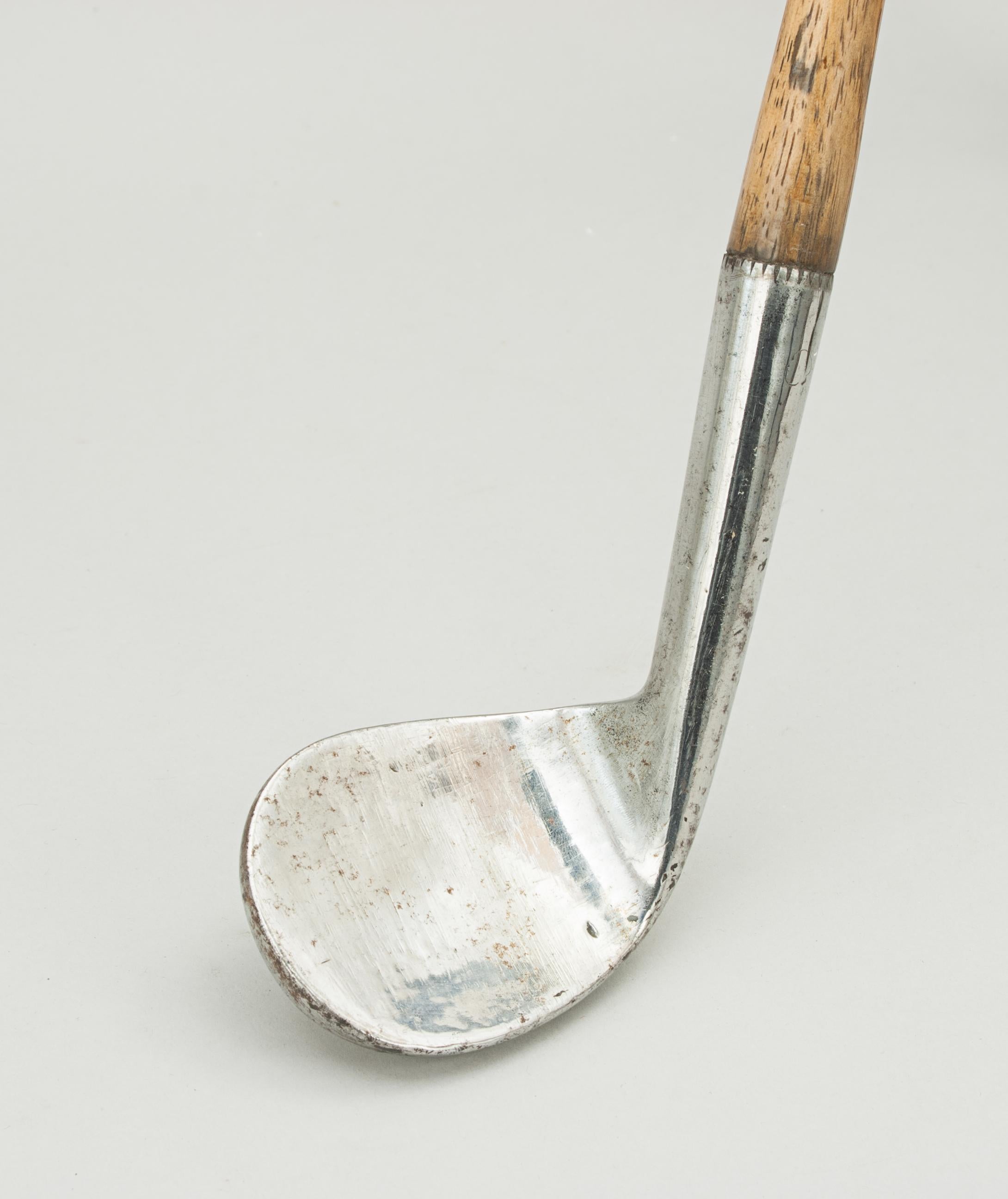 Spalding rut niblick.
A good quality, smooth and dished faced, rut niblick golf club with hickory shaft. The head stamped on the back 'Crescent' hand-forged with the Spalding logo (cleek mark). A nice desirable golf collectible. The club head has