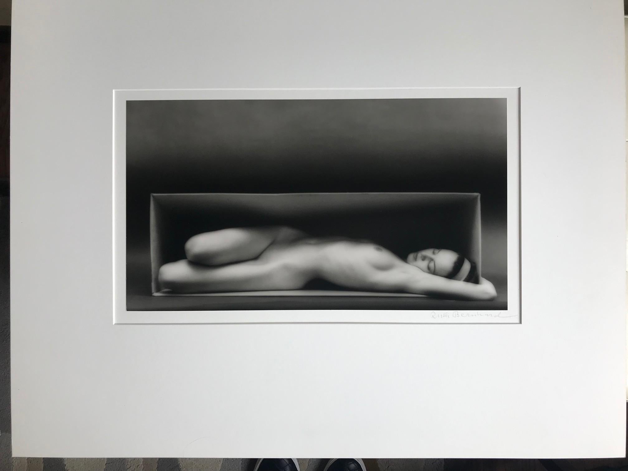 Ruth Bernhard's most famous photograph; In The Box. Beautiful quality print with incredible tonal range. Rare larger size only a handful ever printed in this size. Hand Printed by Michael Kenna.  
Slight bend on lower left hand side of mat board. 
